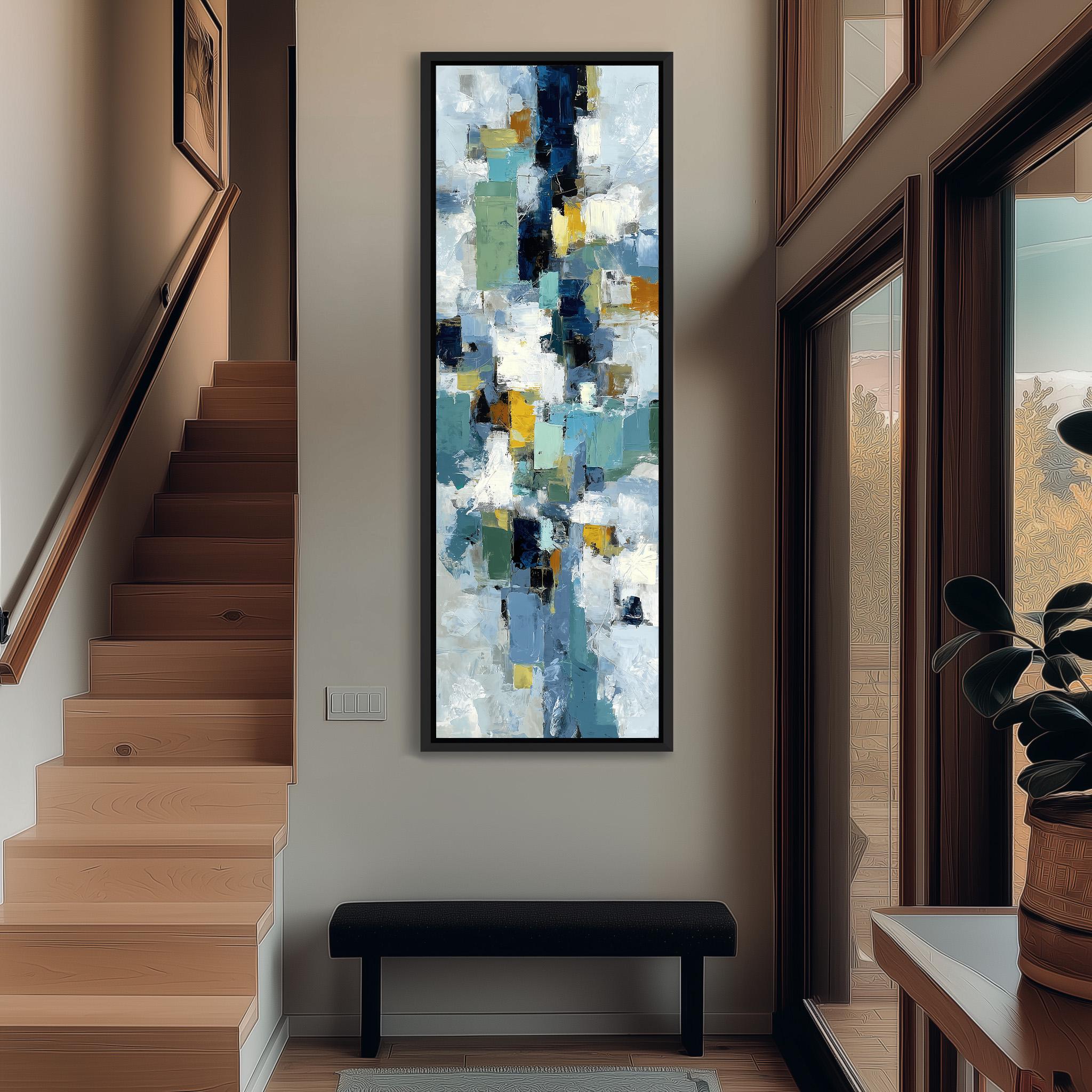 a modern art piece hanging on the wall of a hallway, with a wooden staircase and a bench in the foreground.
