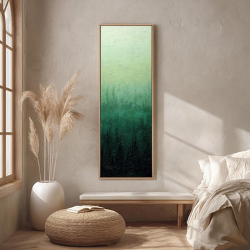 a serene and modern bedroom with a large painting of a forest scene hanging on the wall, a white bed with a white pillow, a white vase with tall potted plants, and a woven ottoman in front of the bed.