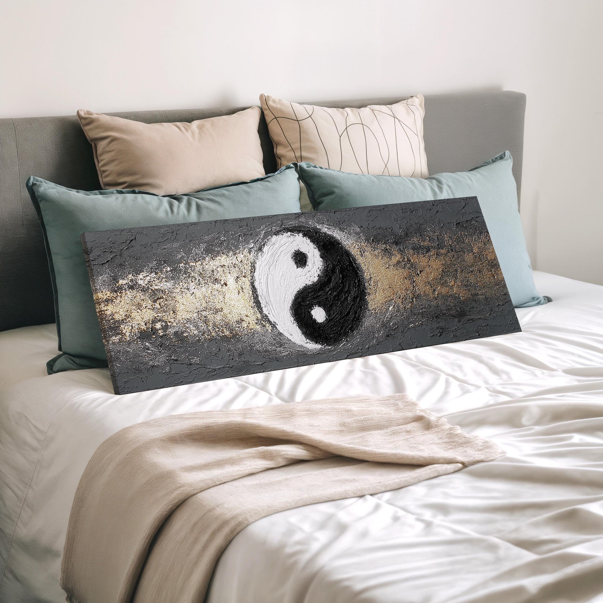 a bedroom with a bed and a large canvas featuring a black and white yin and yang symbol.