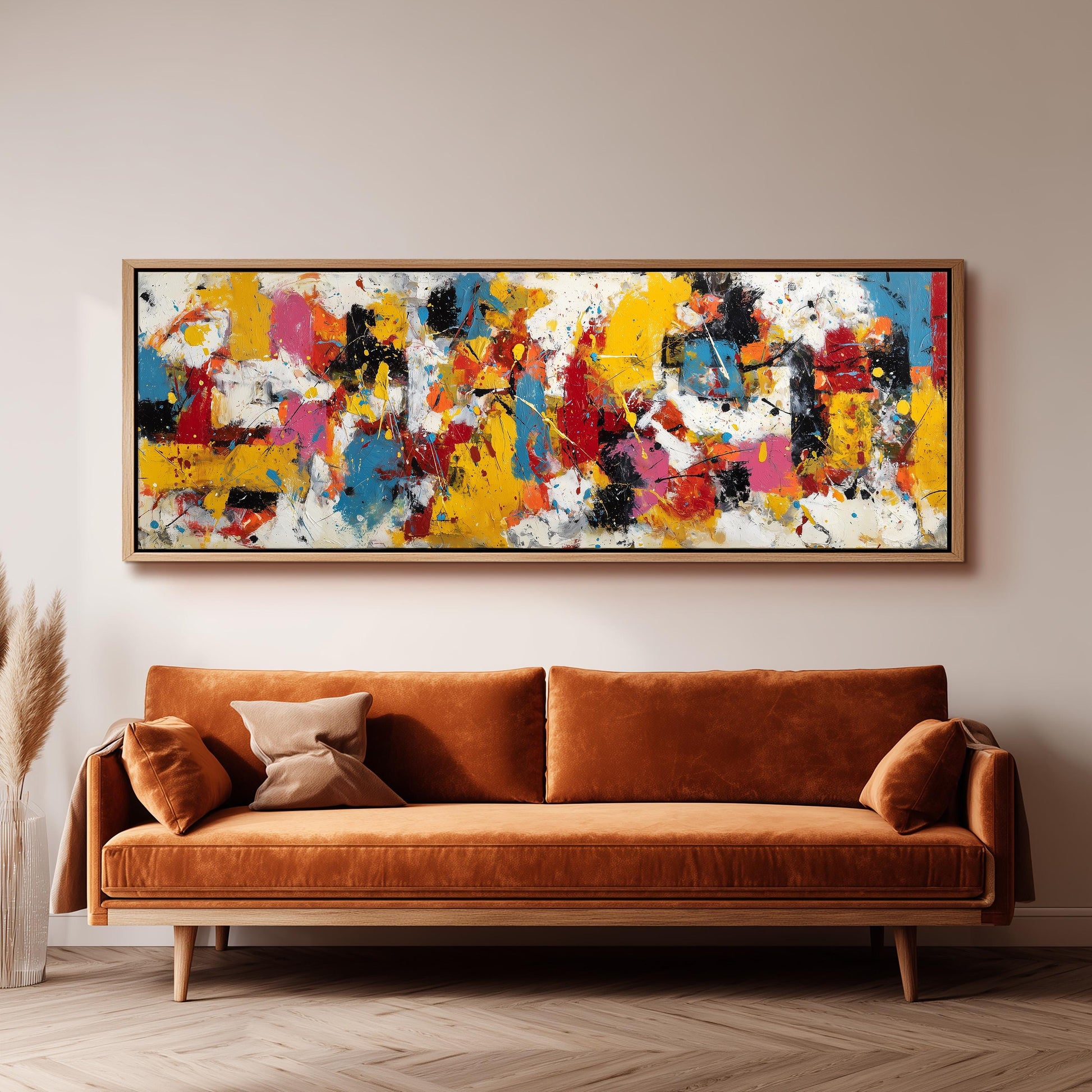 a large, colorful abstract painting hanging on a wall above a brown sofa.