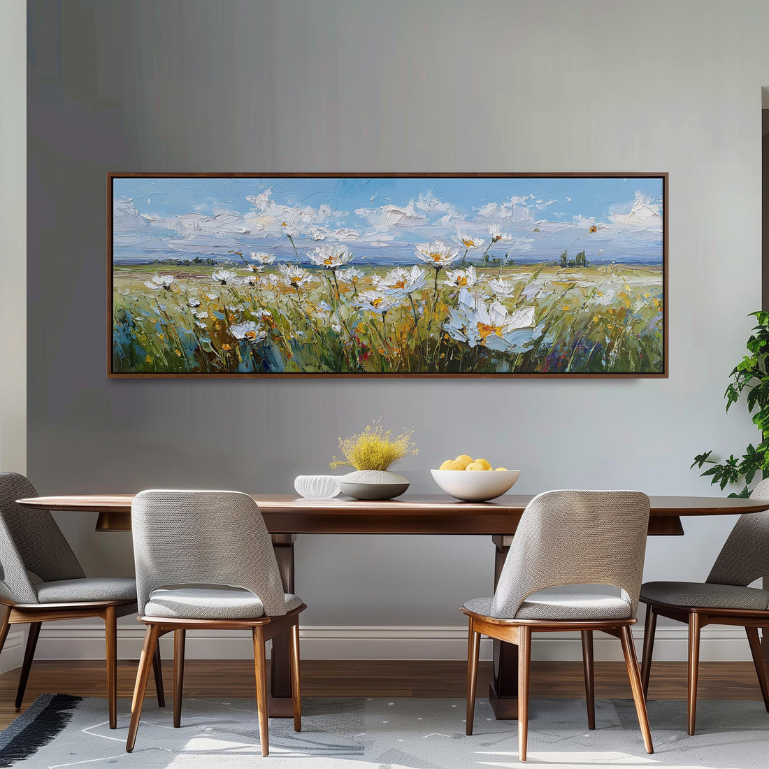 a dining room with a large painting of a field of flowers hanging on the wall above a wooden dining table with four chairs. The table is set with a bowl of fruit and a vase of flowers, creating a cozy and inviting atmosphere.