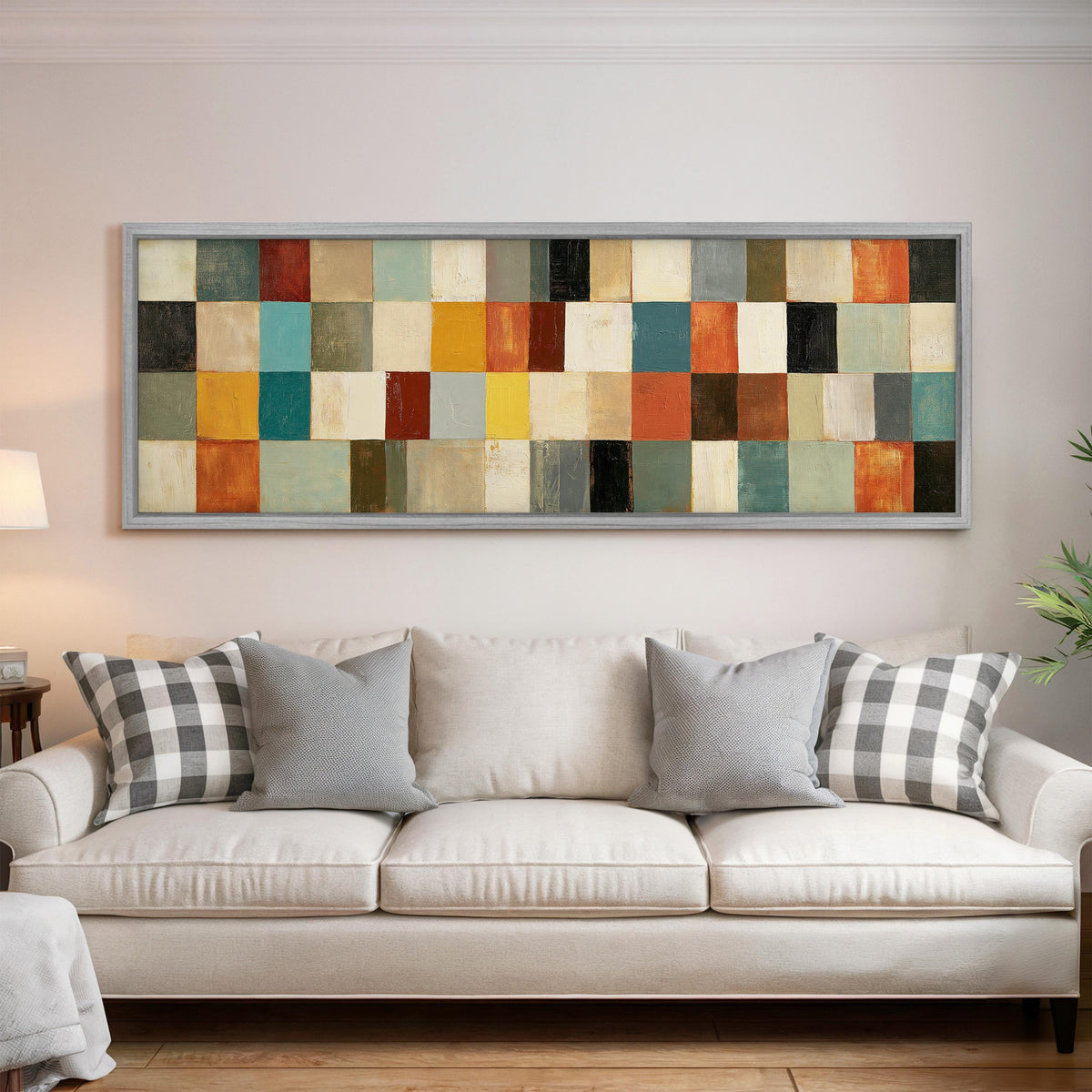 Colorful checkerboard mosaic grid panoramic canvas print above a white sofa in a bright living room