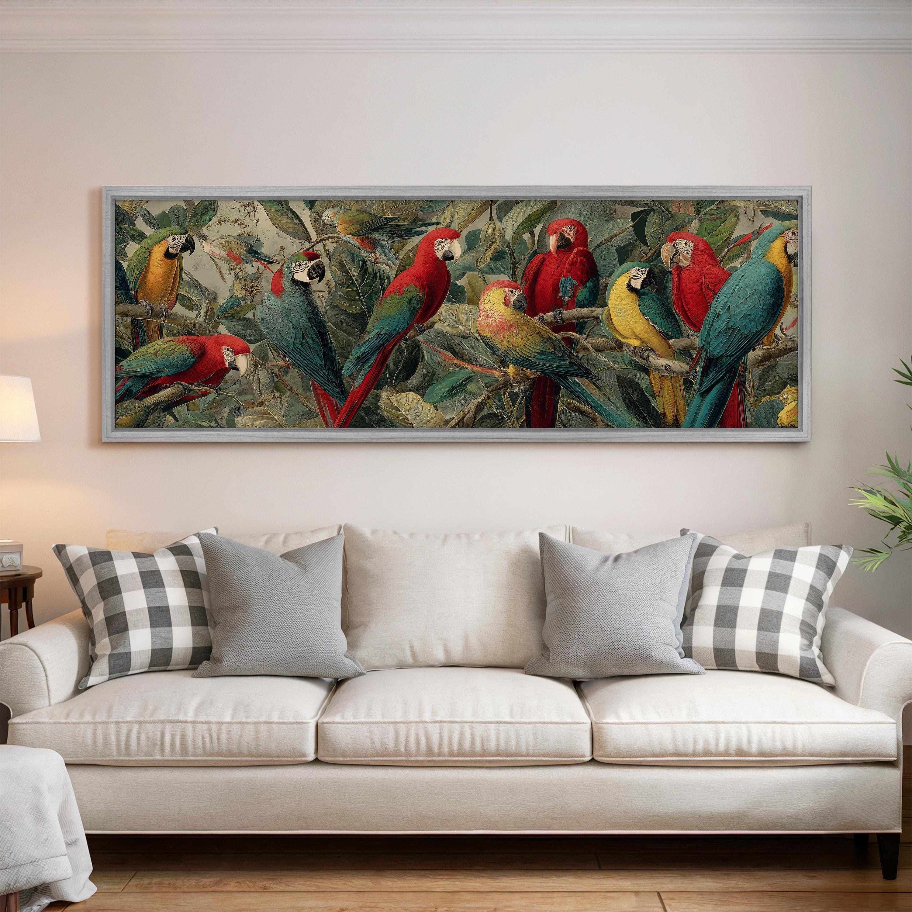 a large, colorful painting of parrots perched on branches, hanging on a wall above a white couch with gray and white plaid throw pillows.