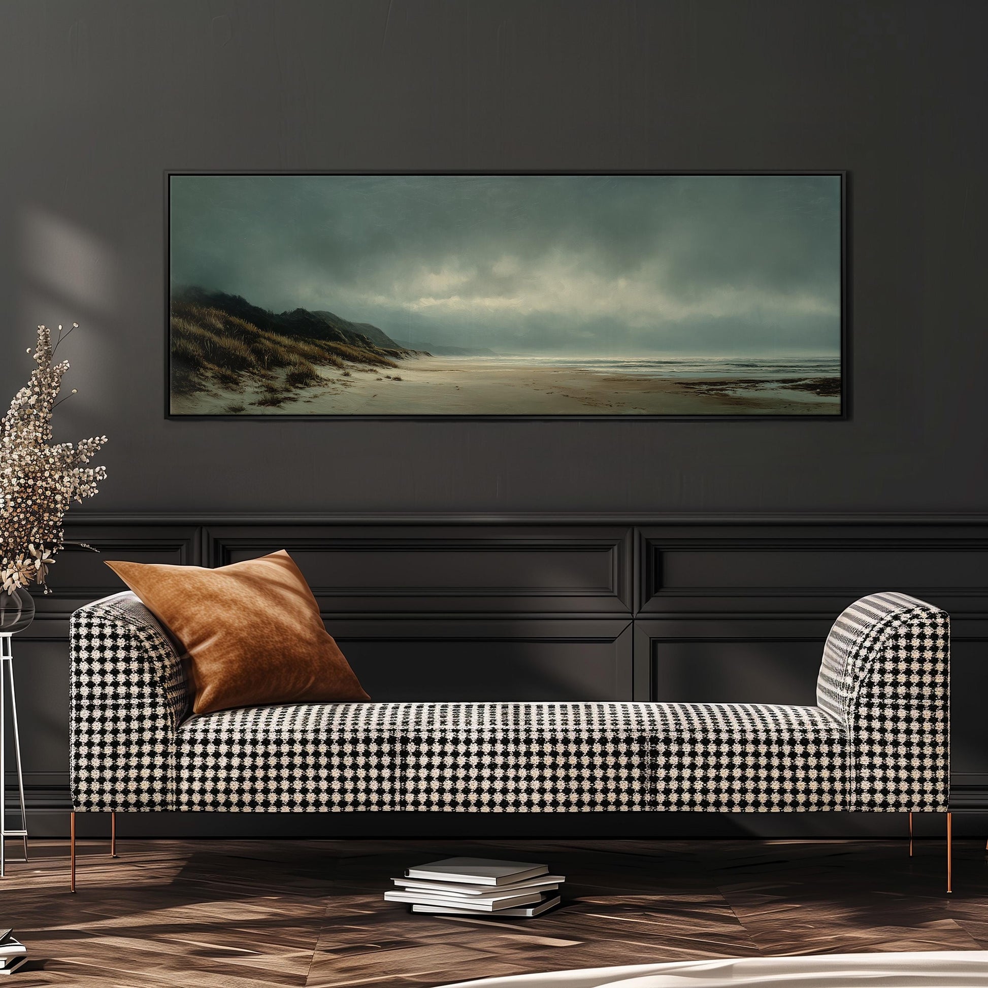 a large, rectangular painting of a beach scene hanging on a dark wall above a black and white checkered sofa with a brown throw pillow.
