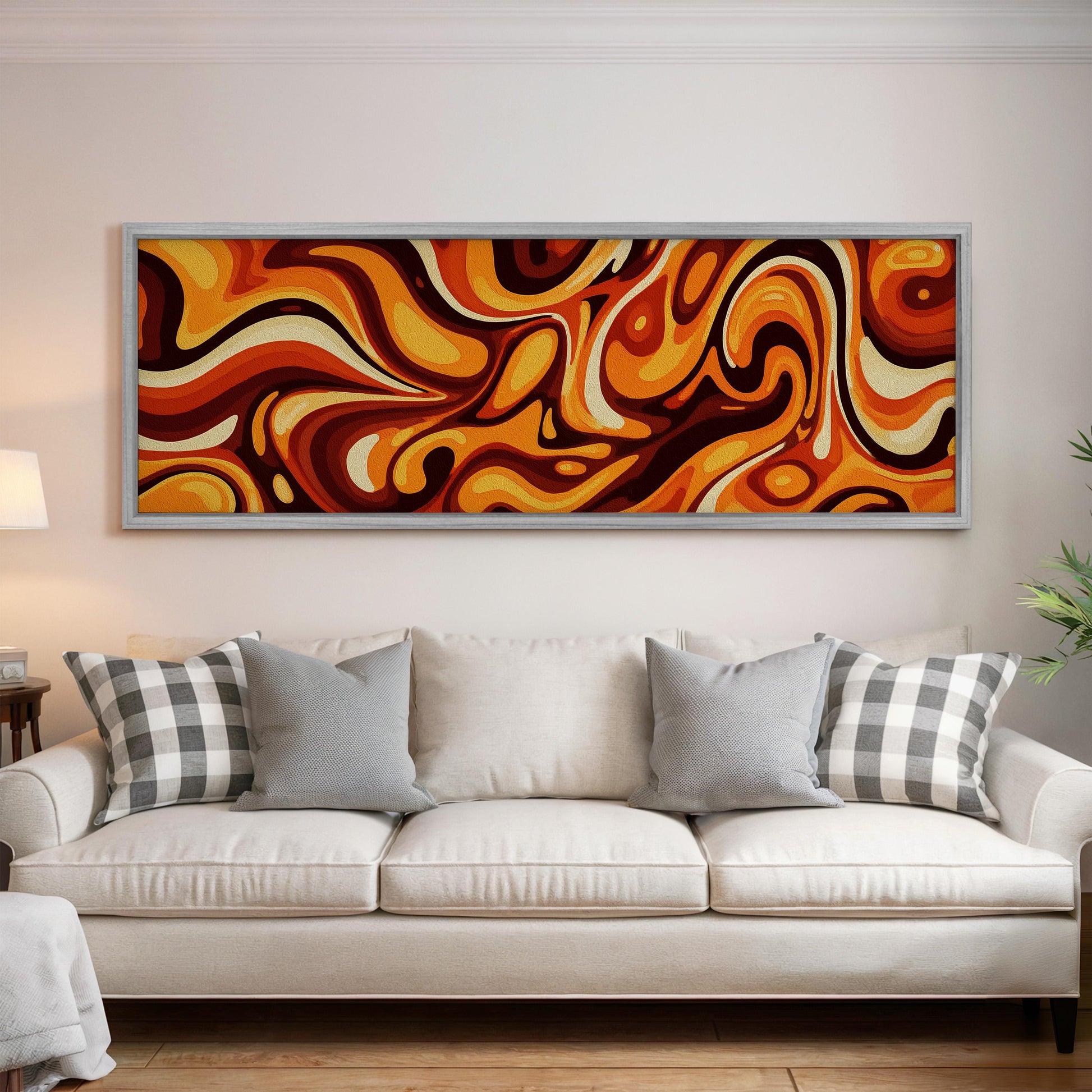 a large abstract painting hanging on a wall above a white couch with gray and white plaid throw pillows.