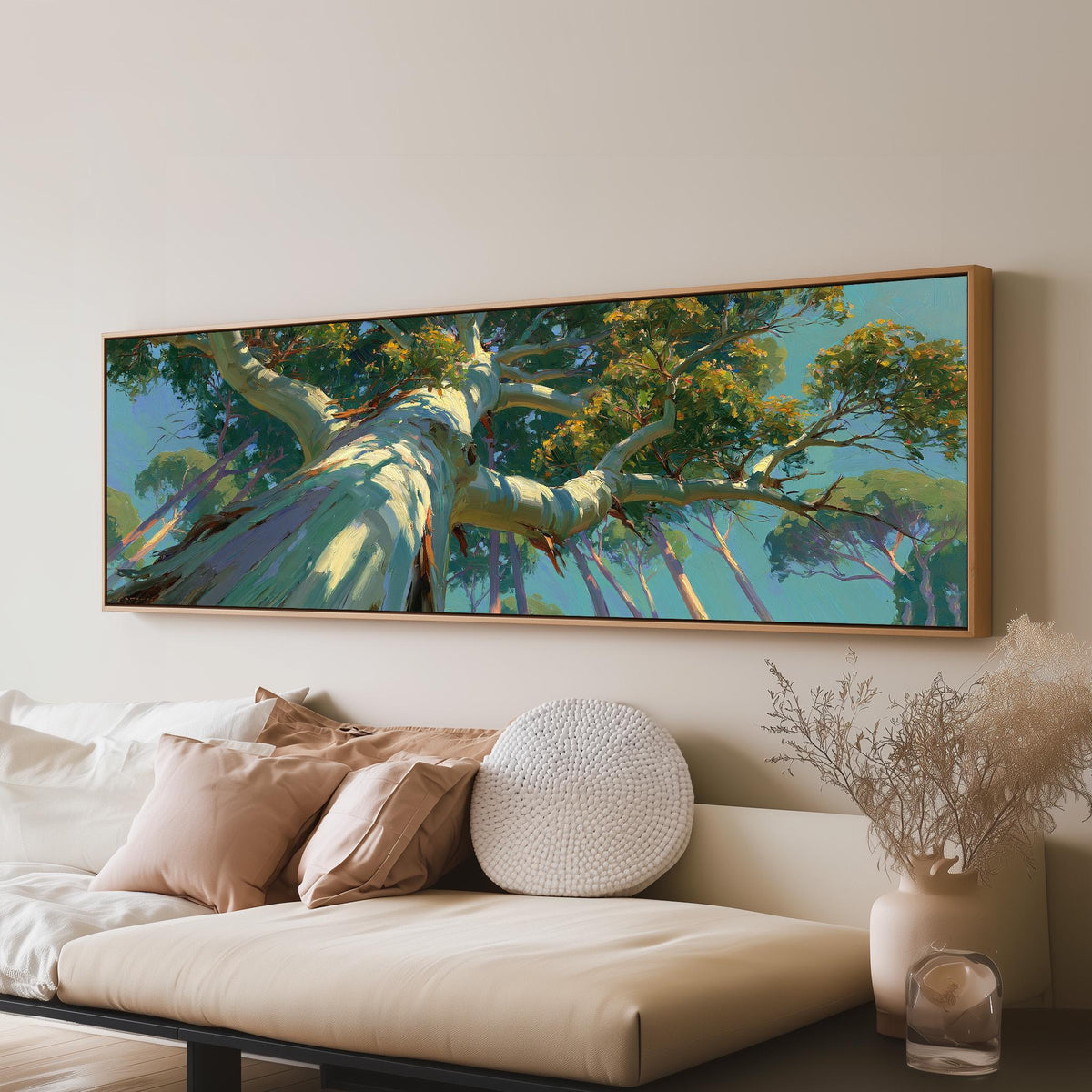 Eucalyptus canopy against a blue sky panoramic canvas print above a sofa in a living room