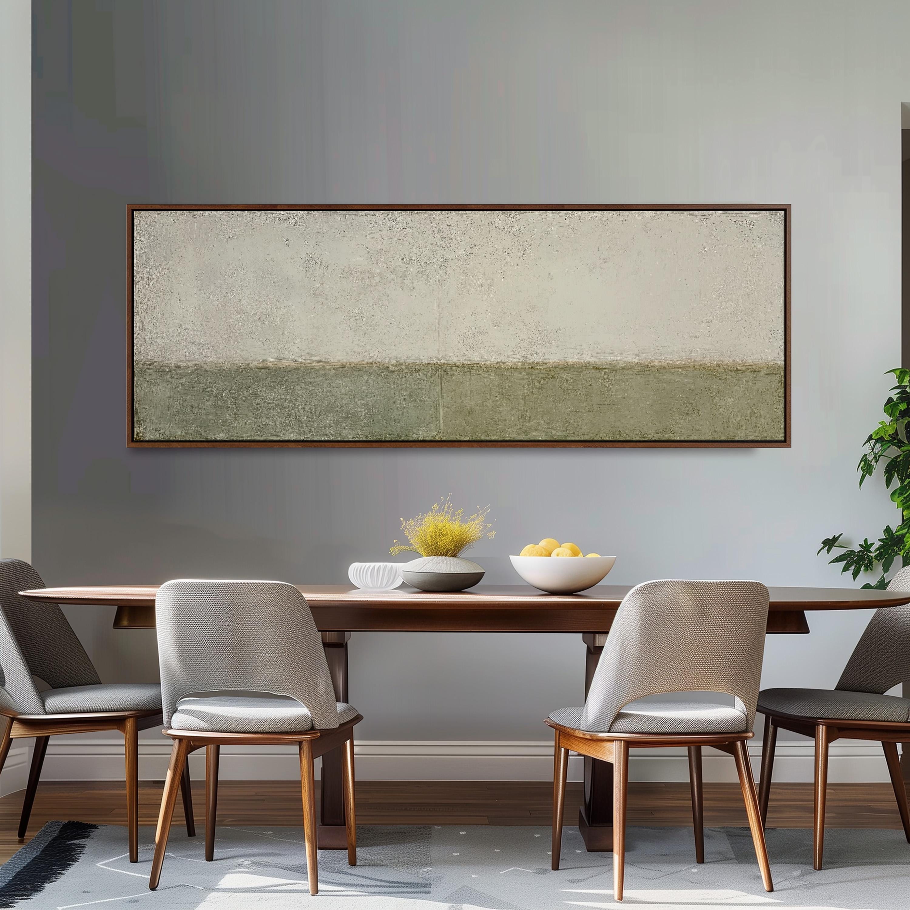 a modern dining room with a wooden table and four gray chairs. Above the table, there is a large rectangular painting hanging on the wall. On the table, there is a bowl of fruit and a vase of flowers.