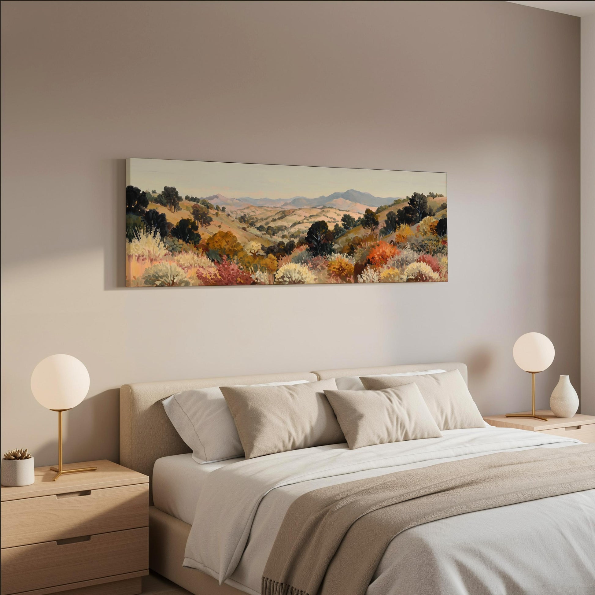a serene bedroom scene with a large bed adorned with white linens and beige throw pillows. Above the bed, a large landscape painting hangs on the wall, featuring a picturesque countryside with rolling hills and trees in various shades of green, orange, and yellow. The room is decorated with two round table lamps on nightstands, and the overall color scheme is neutral, creating a calm and peaceful atmosphere.