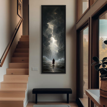 a person standing in a hallway with a large painting of a stormy sea hanging on the wall above a bench.