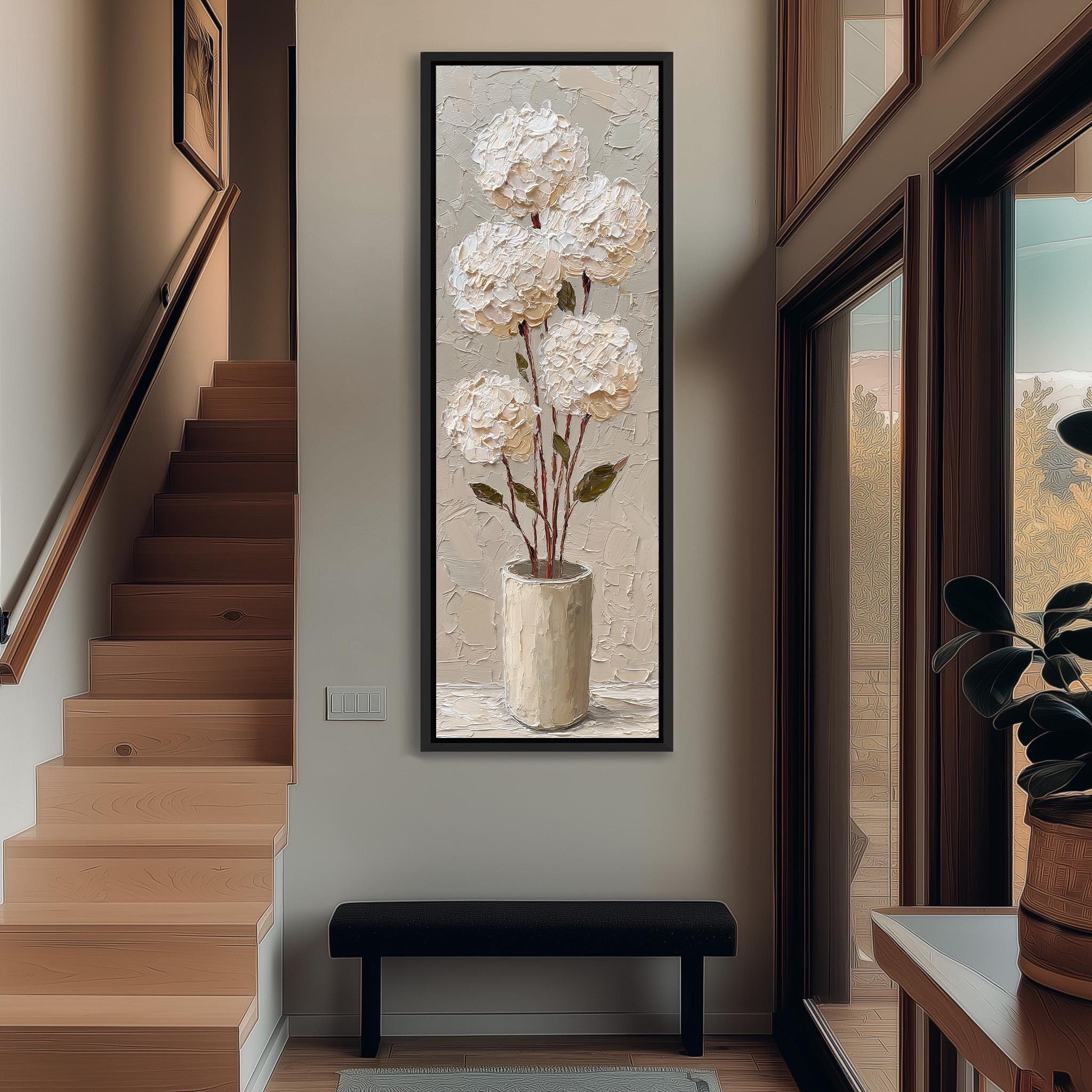 a large painting of white flowers hanging on the wall, with a wooden staircase and a bench in the foreground.