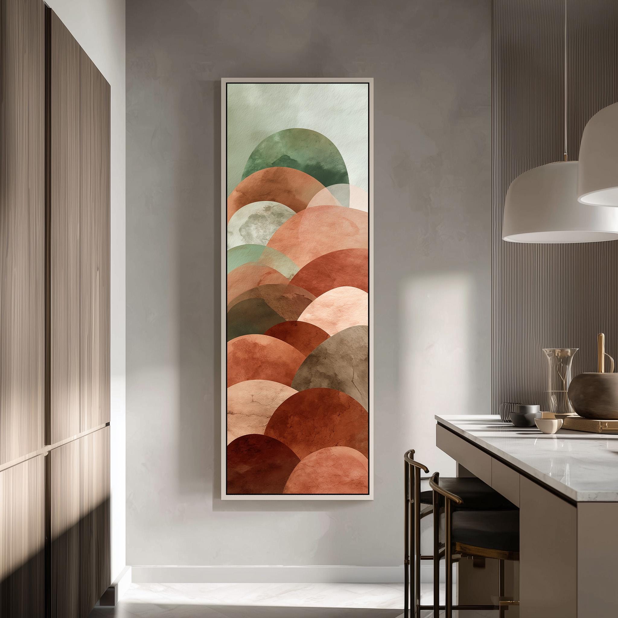 a modern kitchen with a large abstract painting hanging on the wall above a counter. The painting consists of overlapping circles in various shades of orange and brown, creating a visually striking and colorful display.