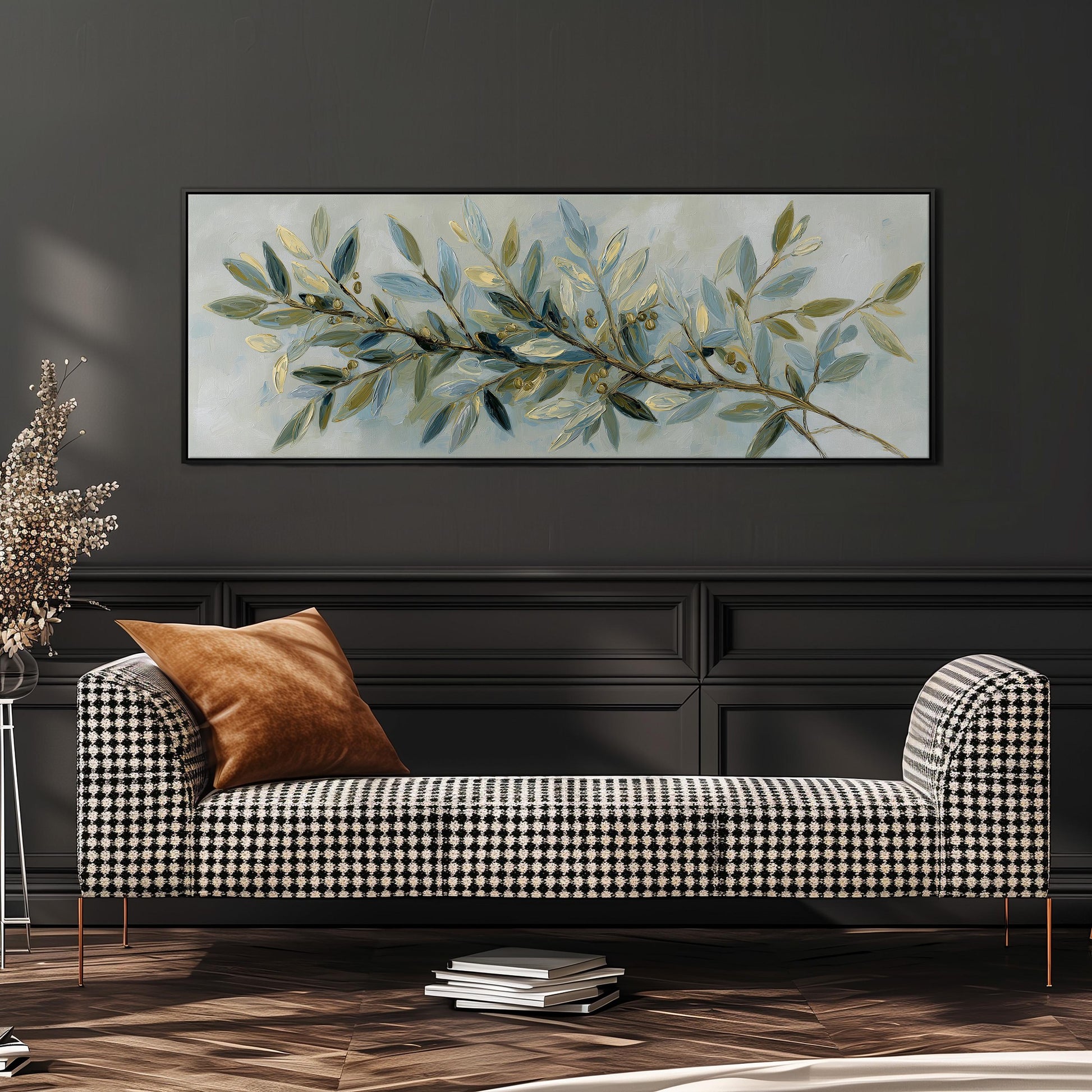 a black and white checkered sofa with a brown throw pillow, set against a dark wall with a large painting of a branch with green leaves hanging above it.