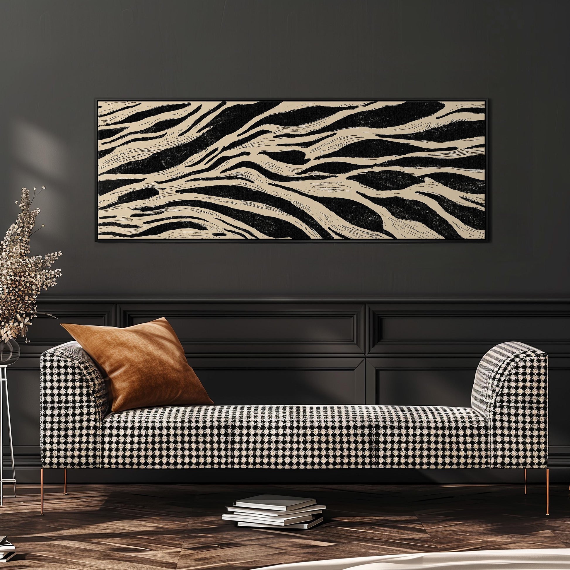 a modern living room with a black and white checkered sofa, a stack of books, and a large abstract painting on the wall.