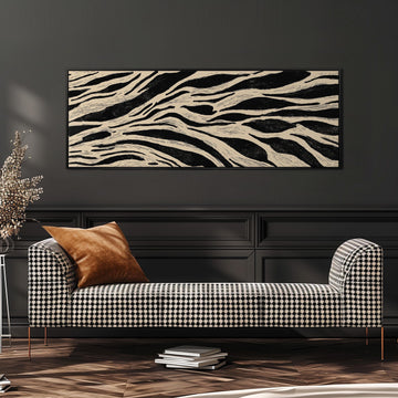 a modern living room with a black and white checkered sofa, a stack of books, and a large abstract painting on the wall.
