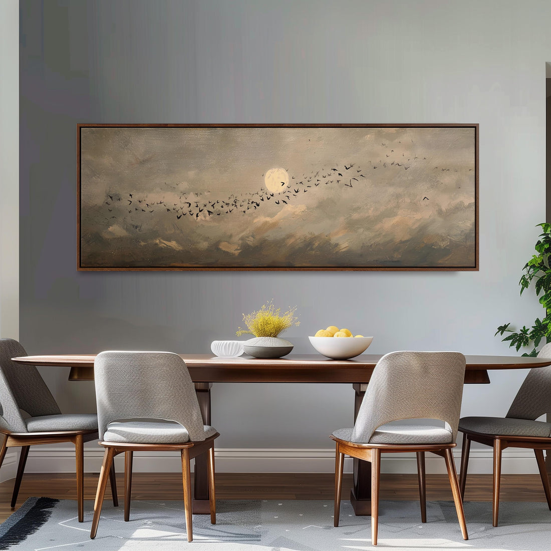 a dining room with a large painting of a flock of birds in the sky above a wooden table. The table is set with a bowl of fruit and a vase of flowers, creating a cozy and inviting atmosphere.