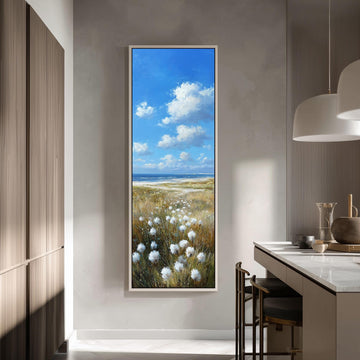 a large painting of a field with white flowers hanging on a wall in a modern kitchen.