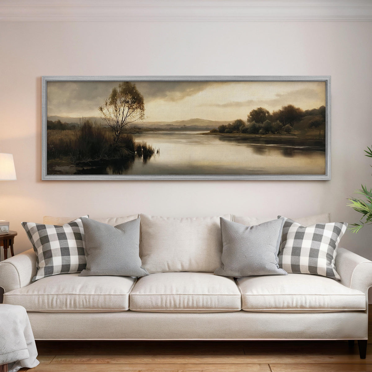 Misty river reflection at dusk panoramic canvas print above a white sofa in a bright living room
