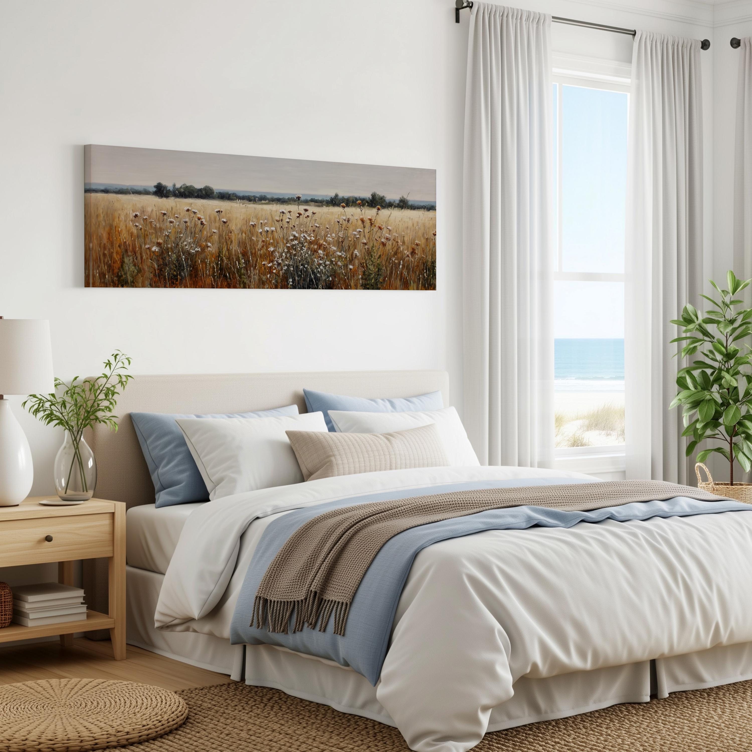 a serene bedroom with a large bed, a nightstand, and a painting of a field of flowers on the wall. The room has white walls, a large window with white curtains, and a view of the ocean.