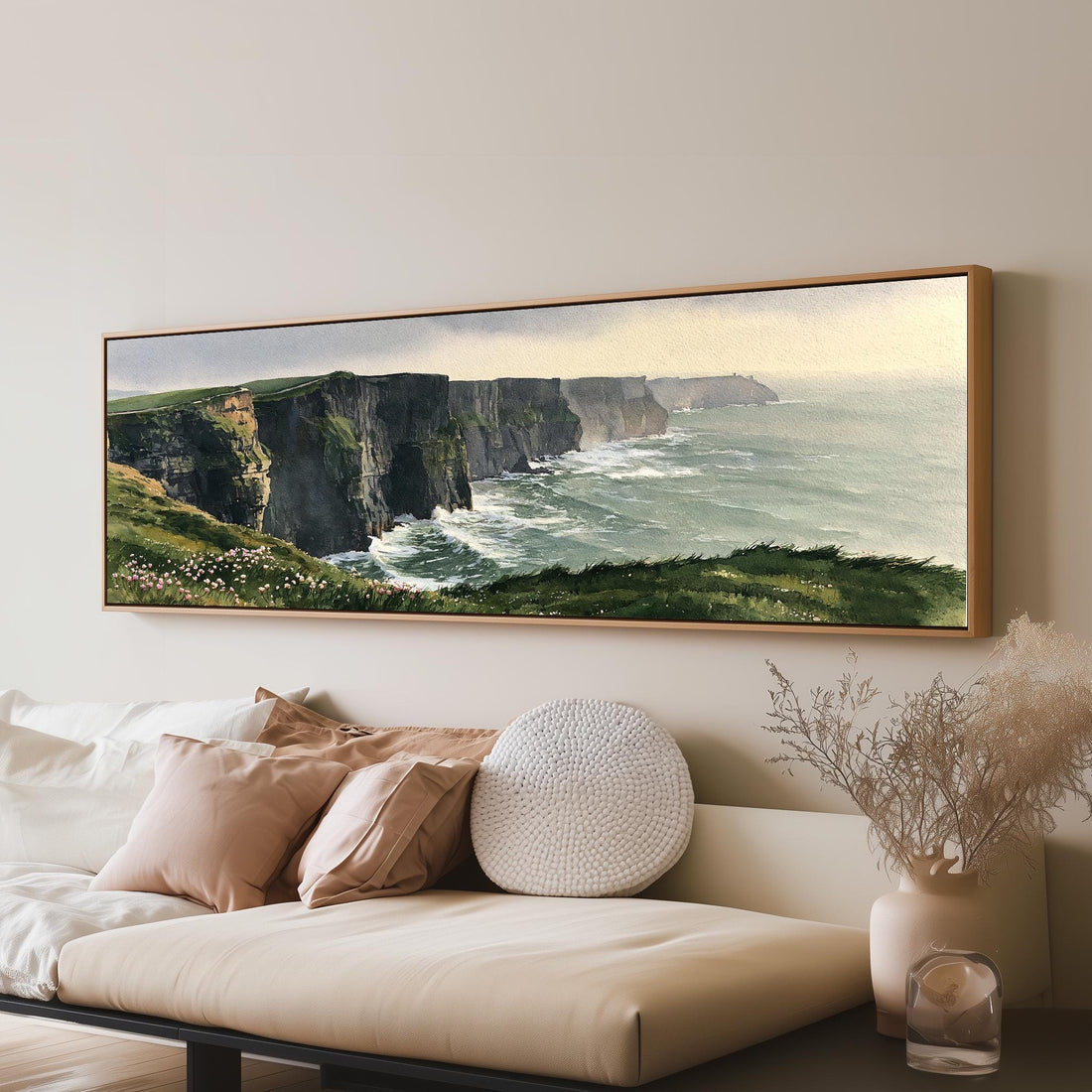 Green sea cliffs with wildflowers long horizontal canvas print above a sofa in a living room