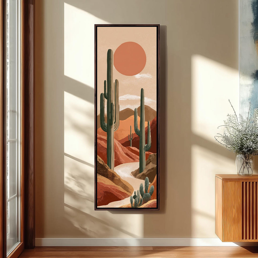 a serene desert landscape with a large cactus painting hanging on the wall, a white bench, a woven ottoman, and a window with a plant in a white pot.