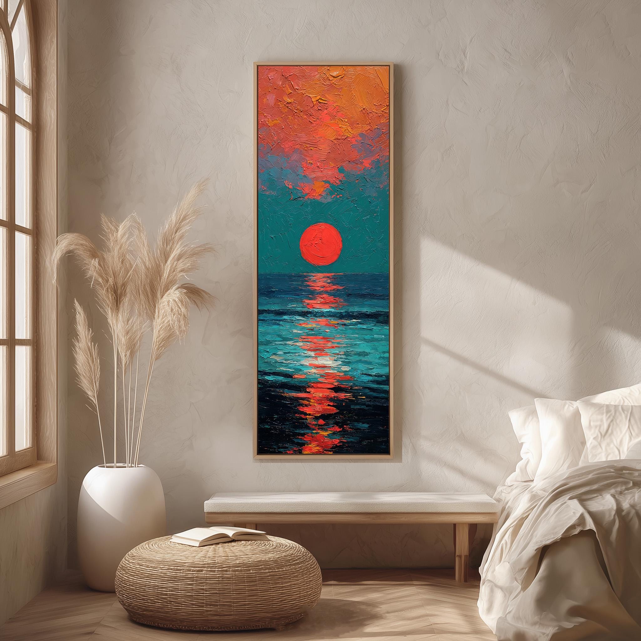 a large, colorful painting of a sunset over the ocean, hanging on a wall in a room with a white bed, a wicker ottoman, and a potted plant.