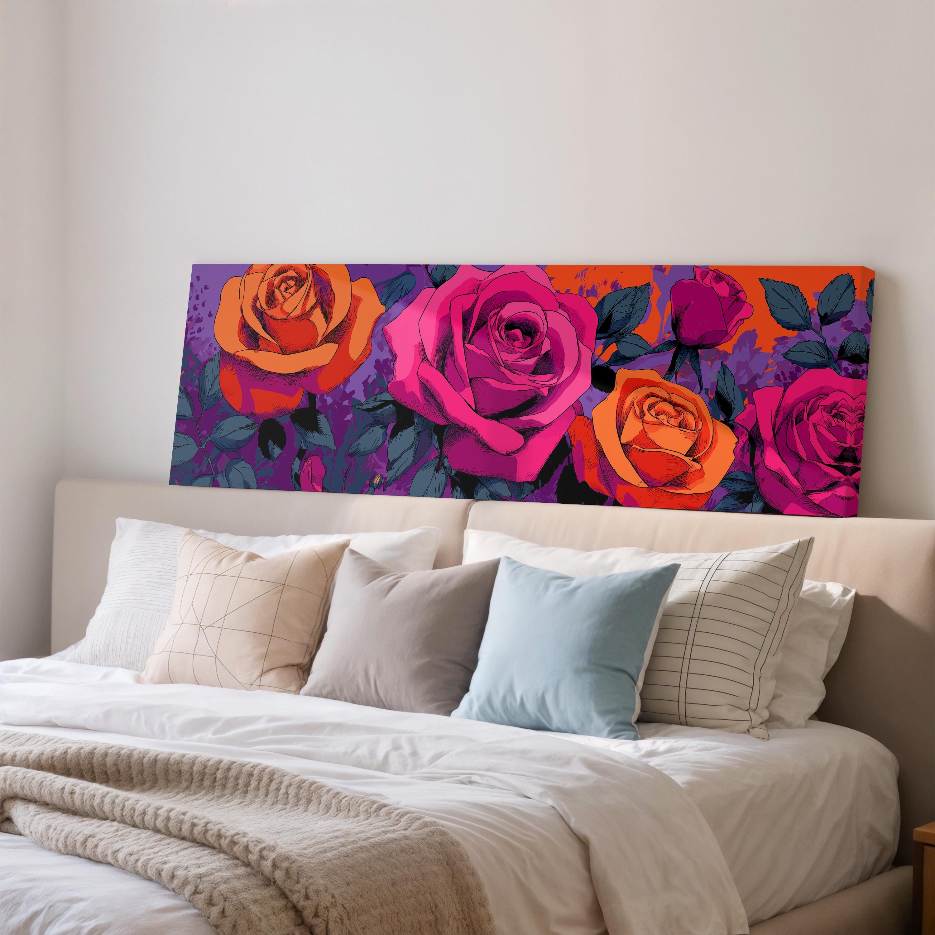 a large, colorful floral print displayed on the wall above a bed with white bedding.