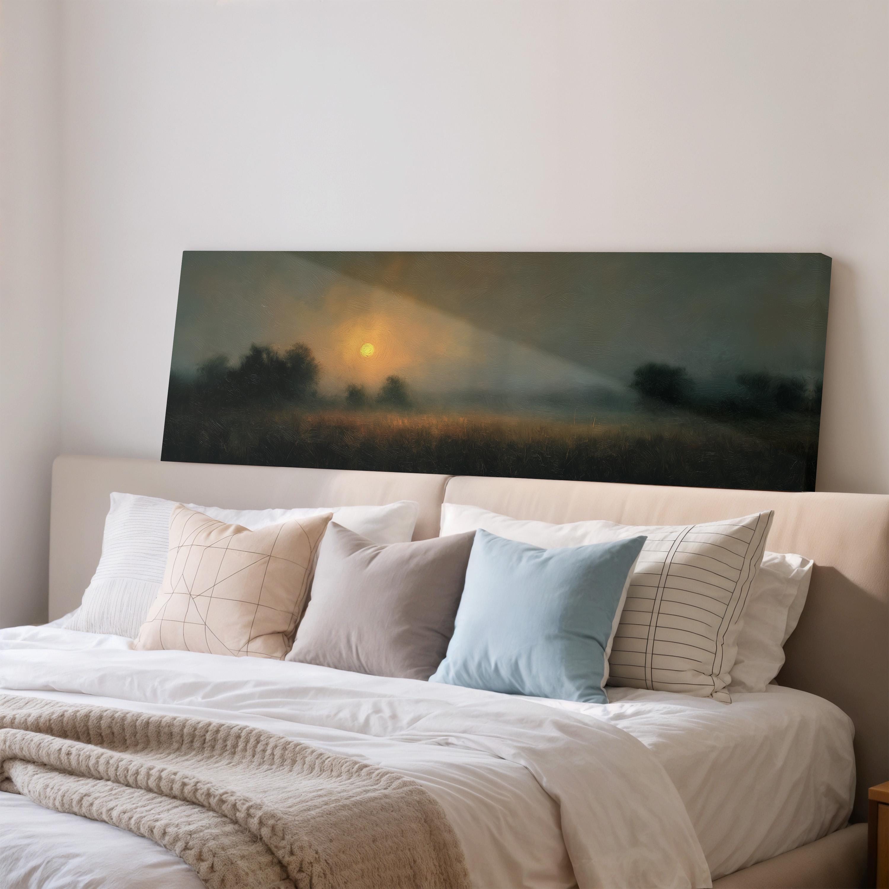 a serene bedroom scene with a large bed adorned with white linens and a variety of colorful pillows. Above the bed, a painting of a sunrise or sunset landscape is displayed on the wall, creating a peaceful and inviting atmosphere.