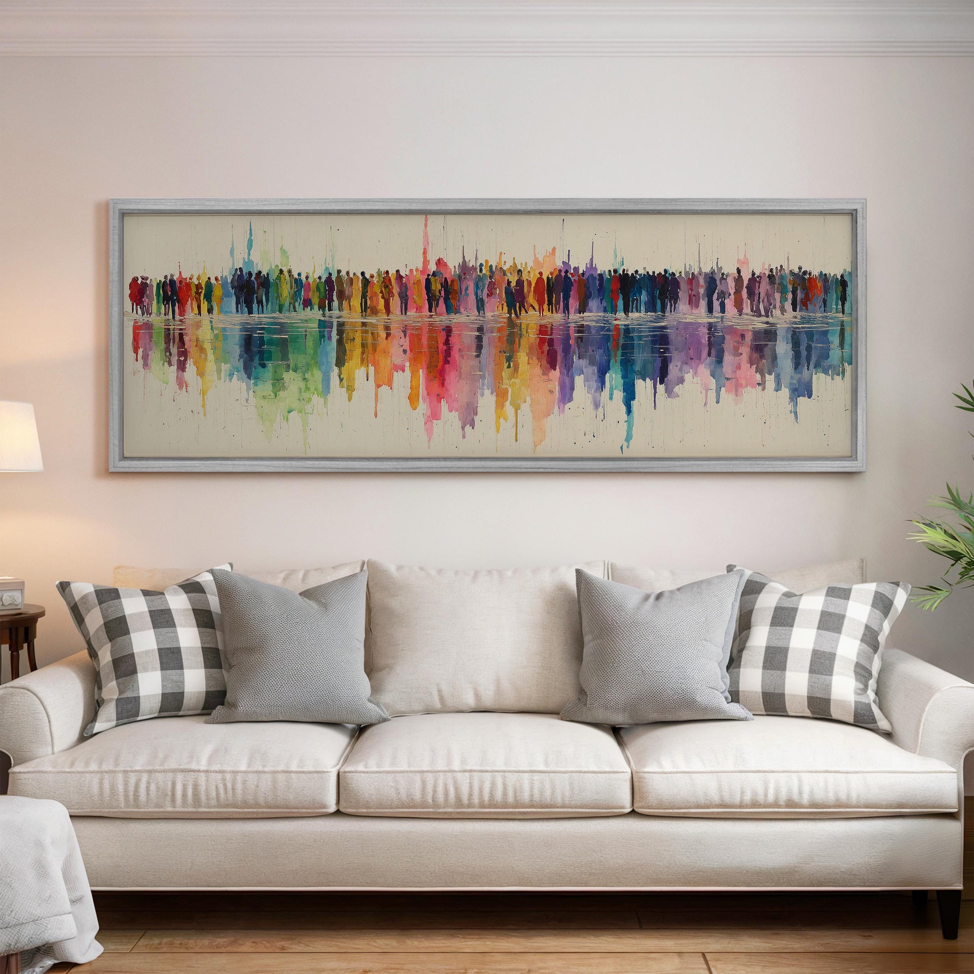 a large, colorful painting hanging on a wall above a white couch with gray and black plaid throw pillows.