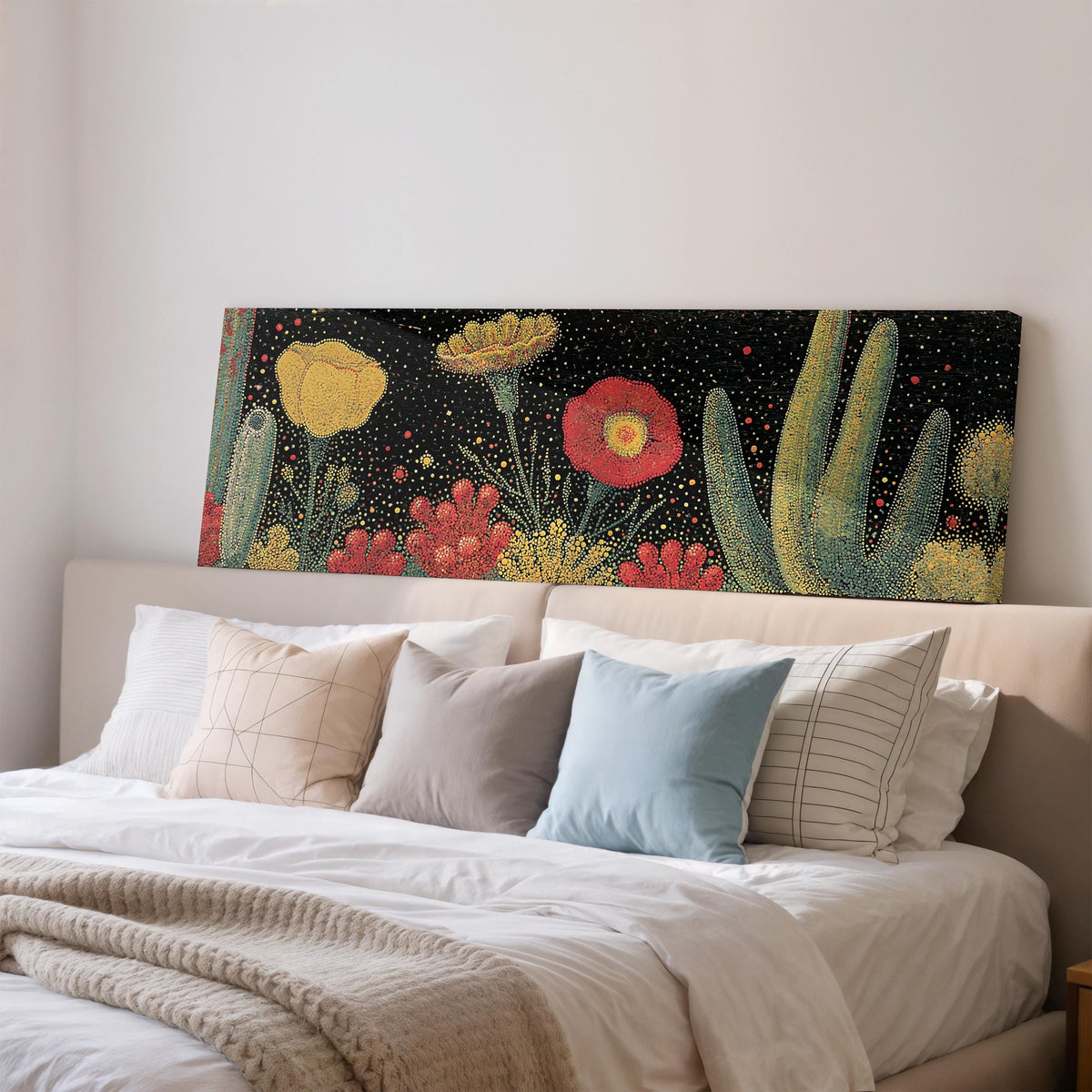 Desert blooms and cacti on black wide panoramic canvas print above a bed in a bedroom