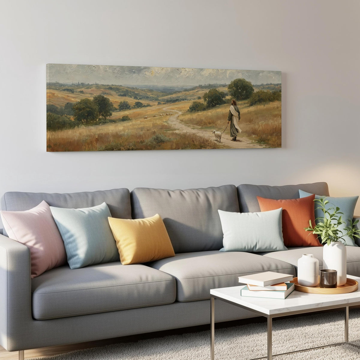 Jesus walking with a sheep on a golden hillside panoramic canvas print above a grey sofa in a living room