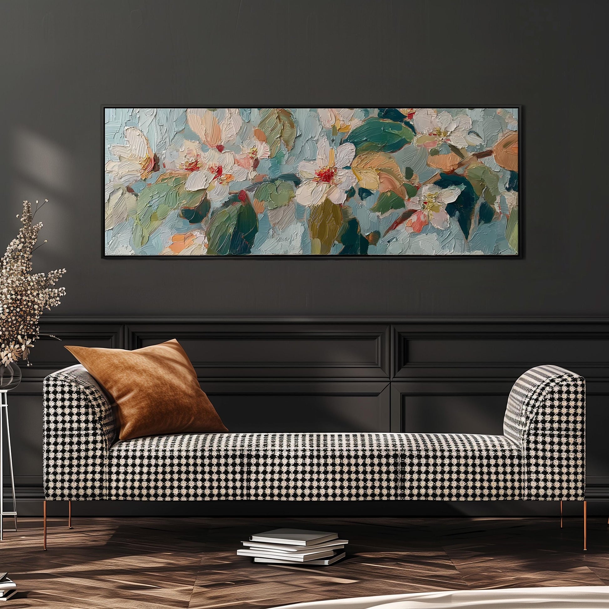 a large, colorful painting of flowers hanging on a wall above a black and white checkered sofa with a brown throw pillow.