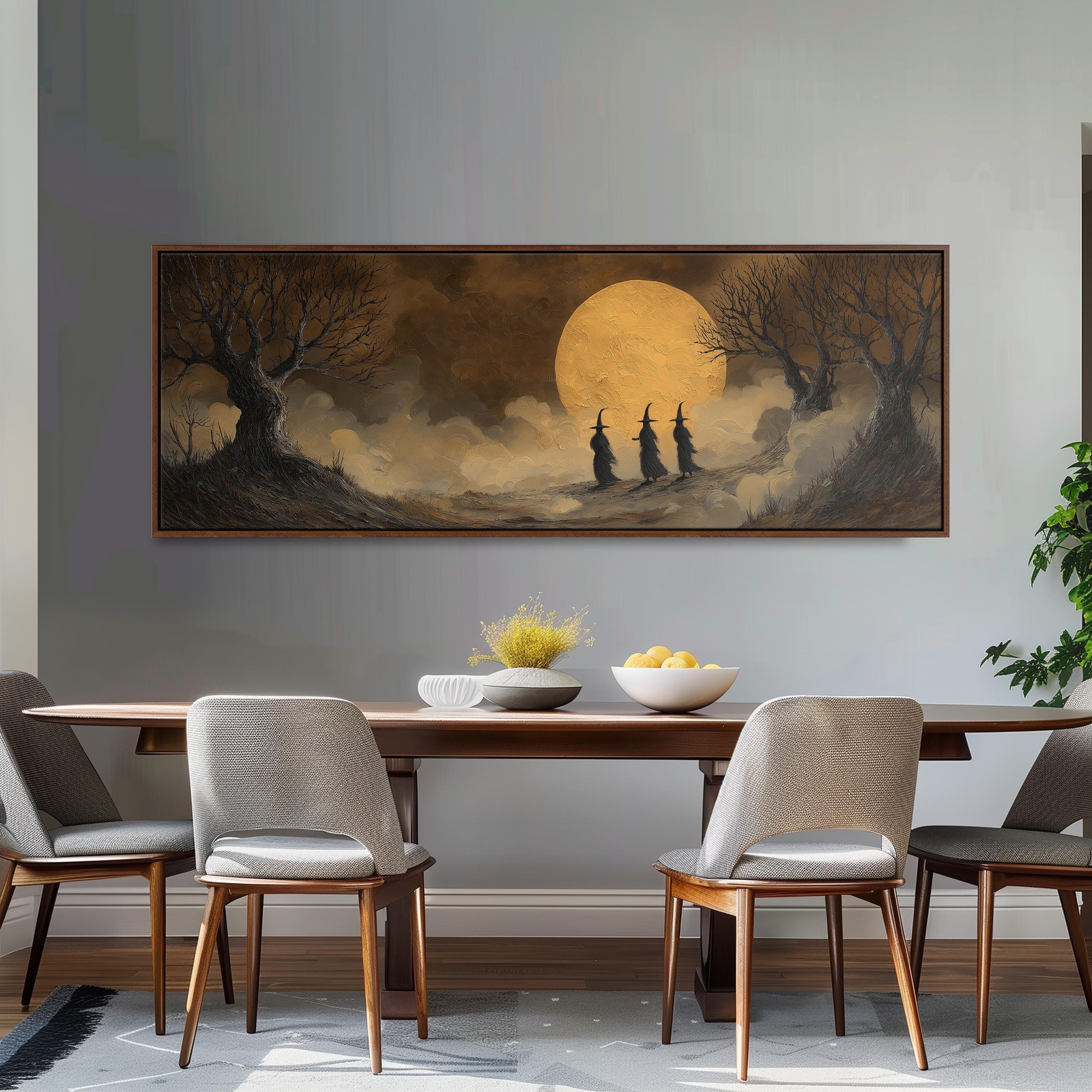 a large painting of a moonlit landscape with three silhouetted figures, hanging on a wall above a wooden dining table with four chairs.