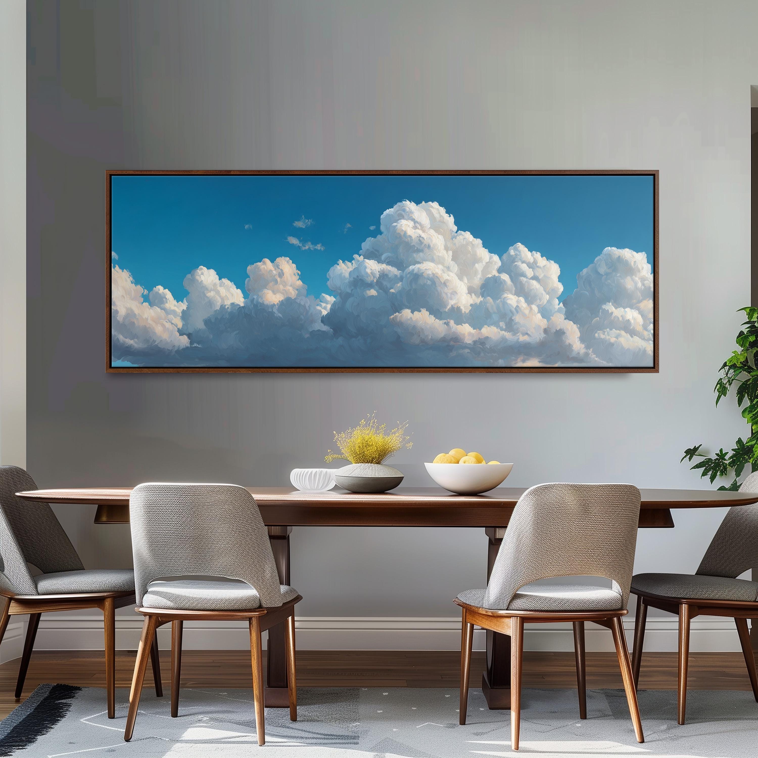 a large painting of a blue sky with fluffy white clouds hanging on a wall above a wooden dining table with four chairs.