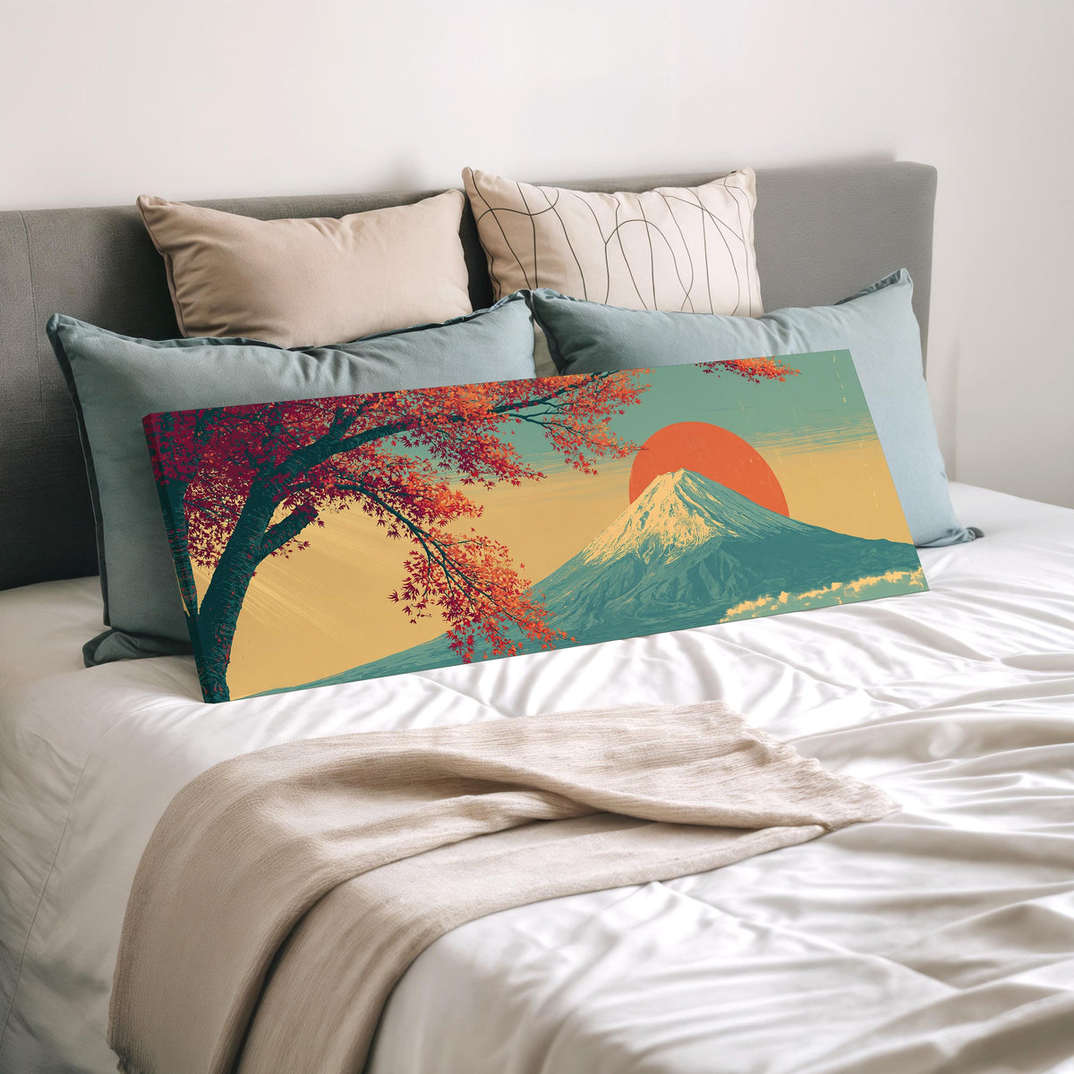 Autumn maple branch and Mount Fuji at sunset wide panoramic canvas print laid on a bed to show its size