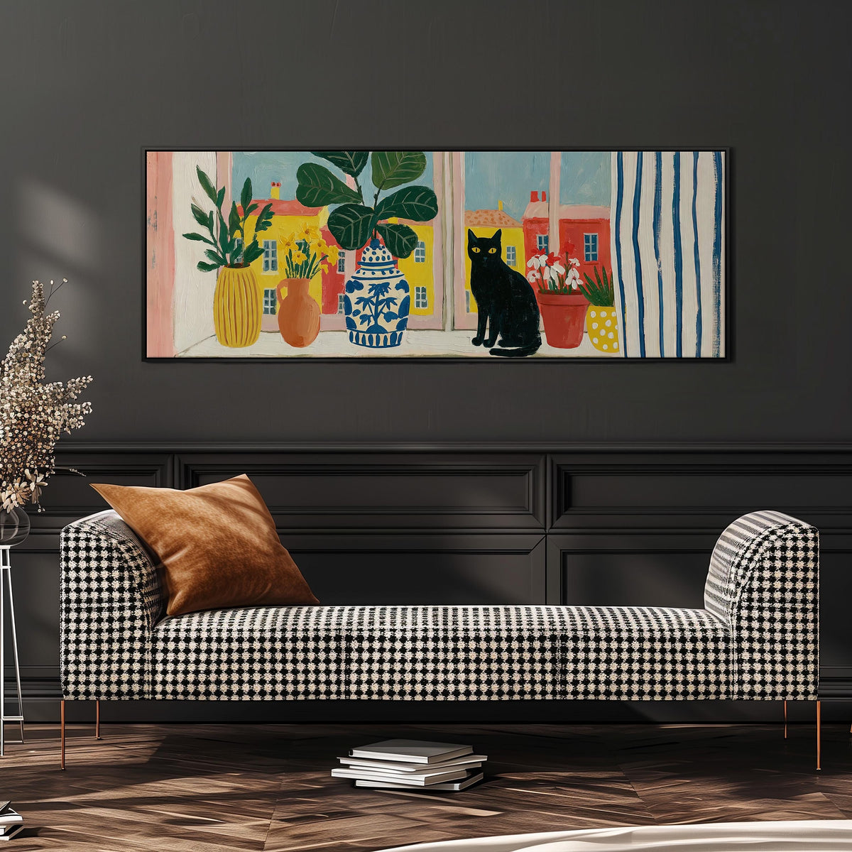 Black cat on a windowsill overlooking a colorful village wide panoramic canvas print above a bench in a dark living room
