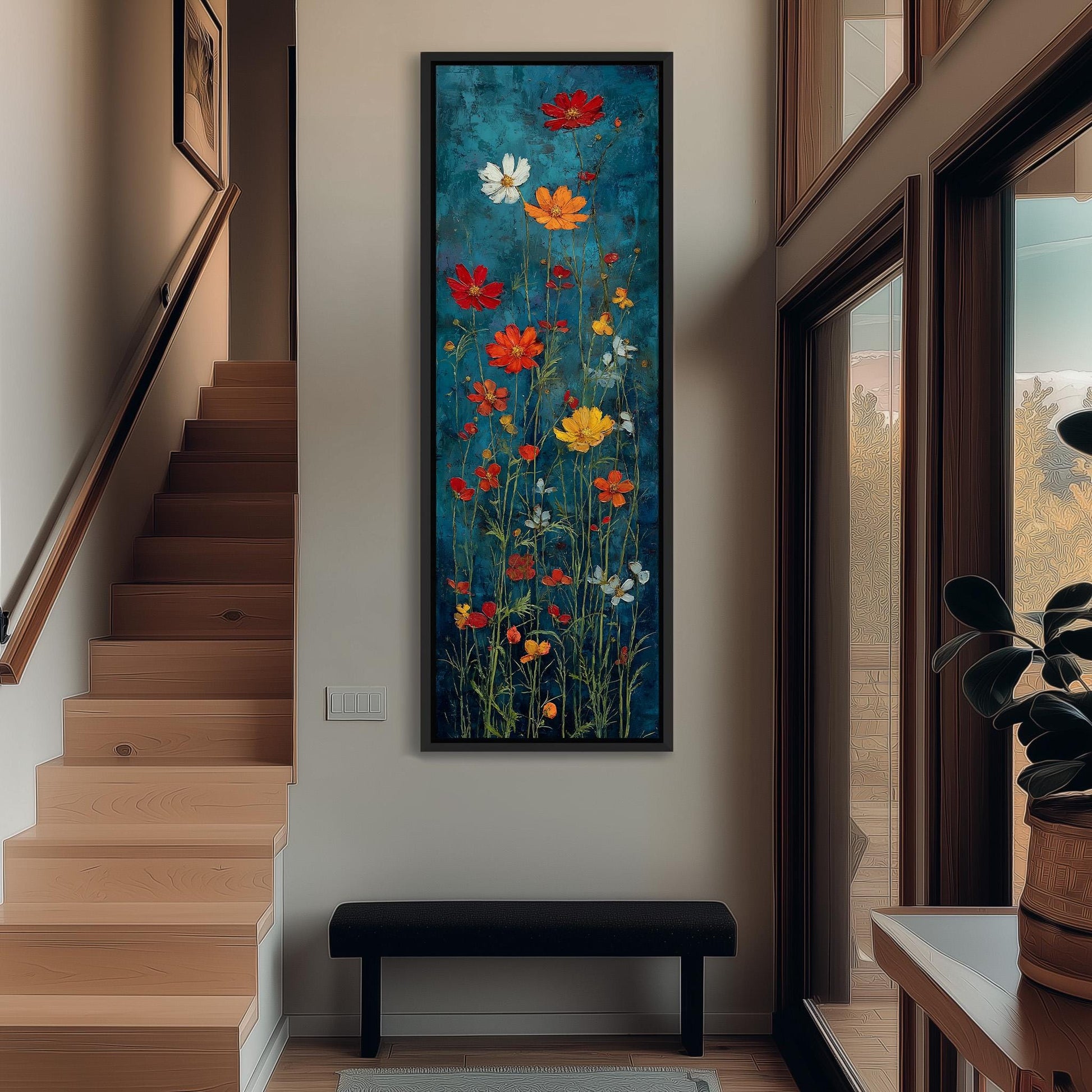 a large, colorful painting of flowers hanging on the wall of a hallway. The painting is framed in black and is the focal point of the room. The hallway has wooden stairs leading up to the painting, and there is a bench in front of the painting. The overall atmosphere of the room is bright and inviting, with the vibrant colors of the flowers adding a lively touch to the space.