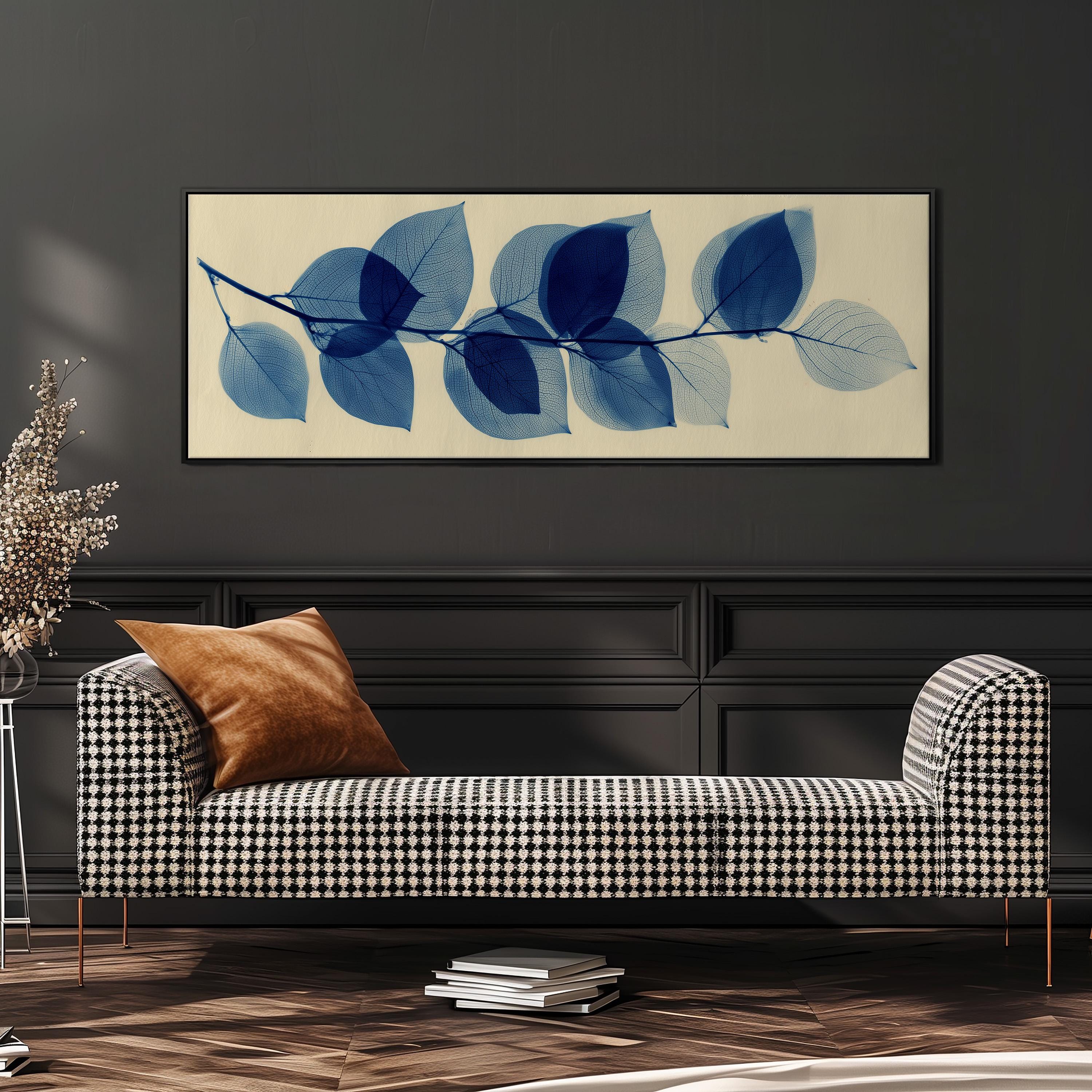 a black and white checkered sofa with a brown throw pillow, set against a dark wall with a framed artwork of blue leafy branches above it.
