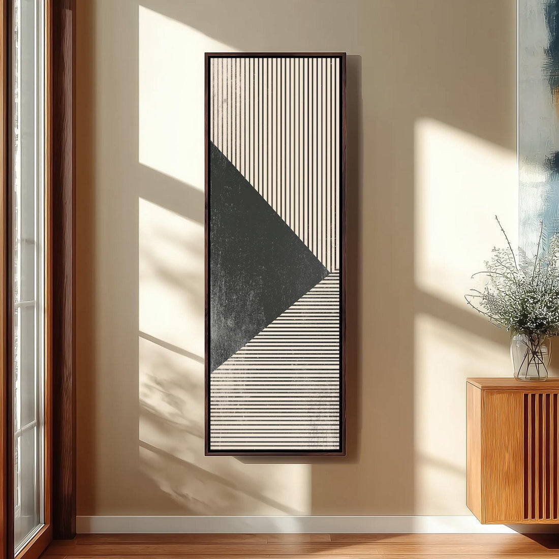 a modern and minimalist interior design, featuring a large abstract painting with a black and white striped pattern hanging on the wall above a black bench. The room has wooden stairs leading up to a door, and a large window with a view of trees outside.