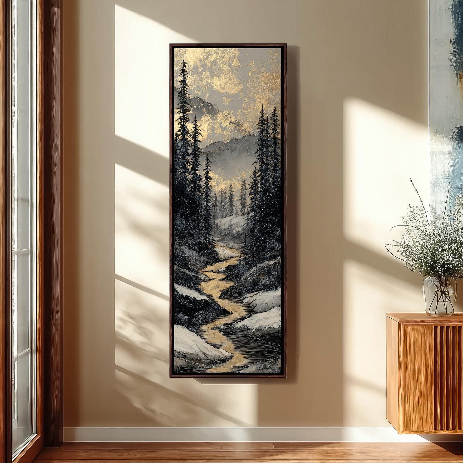 a large framed painting of a snowy mountain landscape with a winding river, hanging on a wall in a room with a wooden floor and a window.