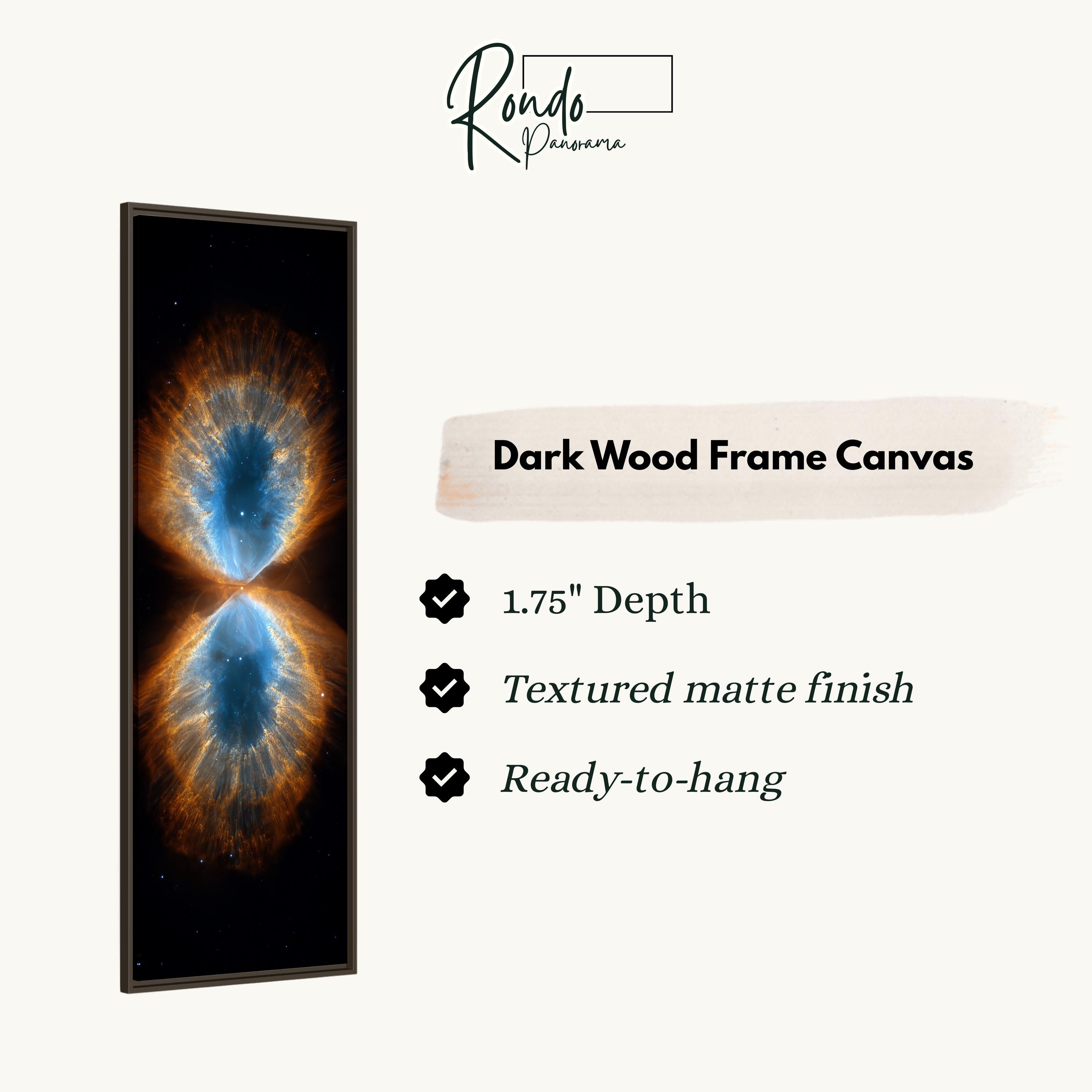 The image is a dark wood frame canvas featuring a captivating image of a nebula, which is a vast cloud of gas and dust in space. The nebula displays a striking combination of blue and orange hues, creating a visually striking and cosmic scene. The canvas is described as having a 1.75" depth, a textured matte finish, and being ready to hang.