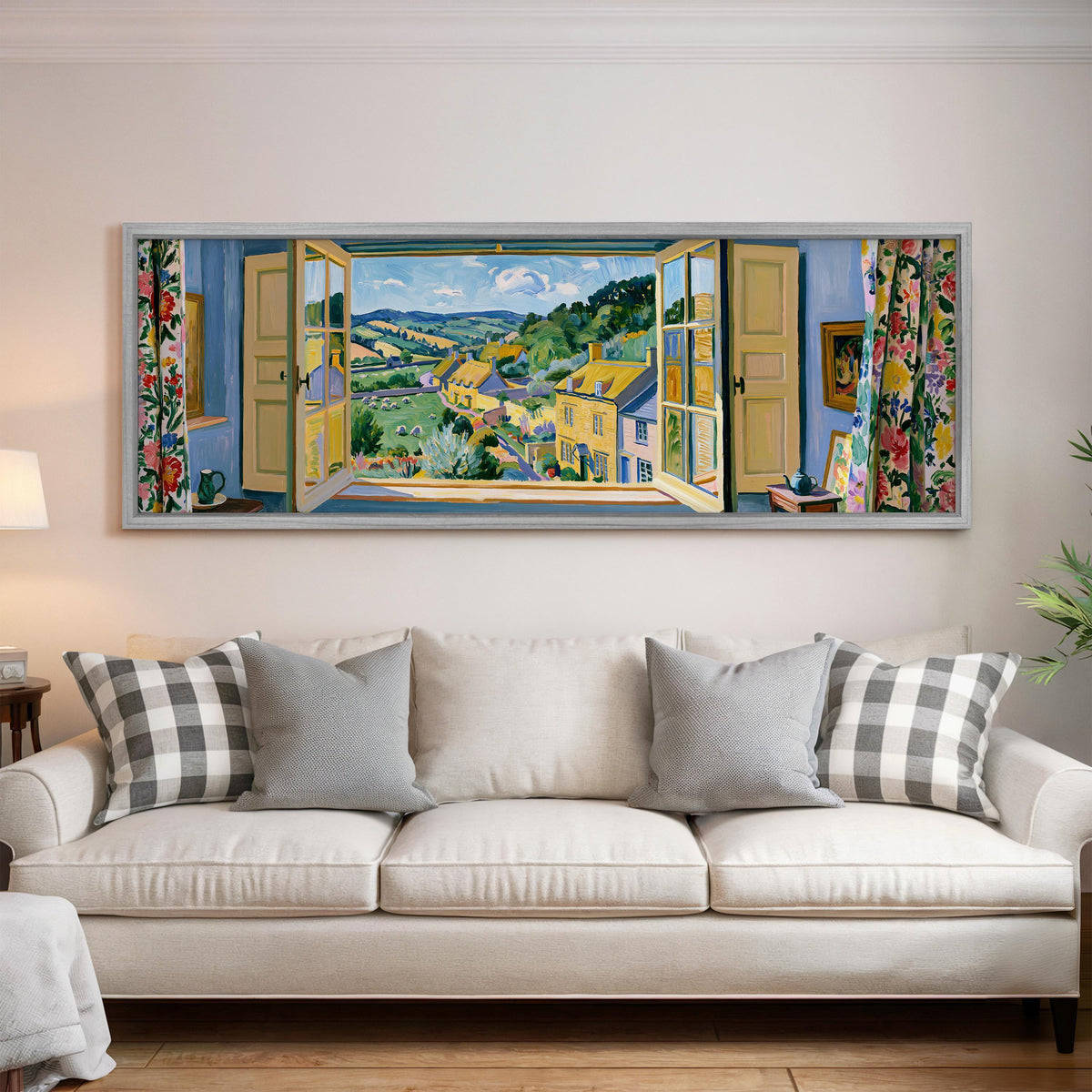 English countryside village through a window panoramic canvas print above a white sofa in a bright living room
