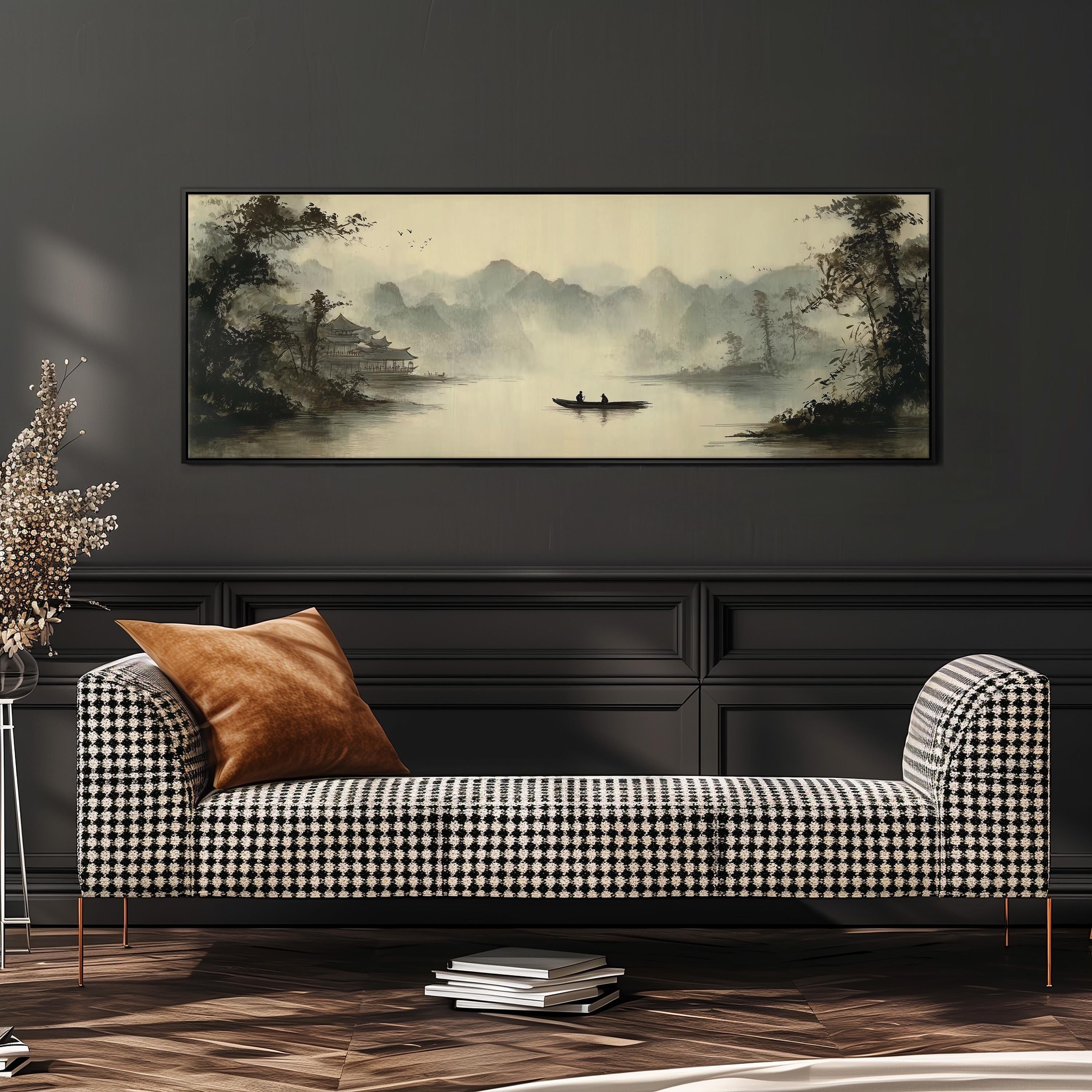a large black and white checkered sofa with a brown throw pillow, positioned in front of a wall with a framed landscape painting depicting a boat on a lake surrounded by mountains.