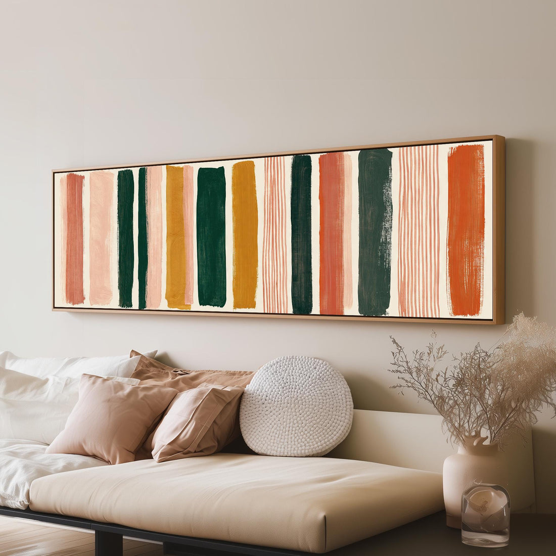 Mixed stripe blocks in terracotta, pink and green long horizontal canvas print above a sofa in a living room