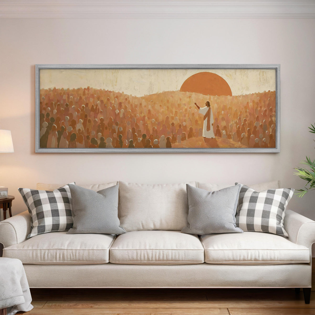 Jesus preaching to a crowd at sunset panoramic canvas print above a white sofa in a bright living room