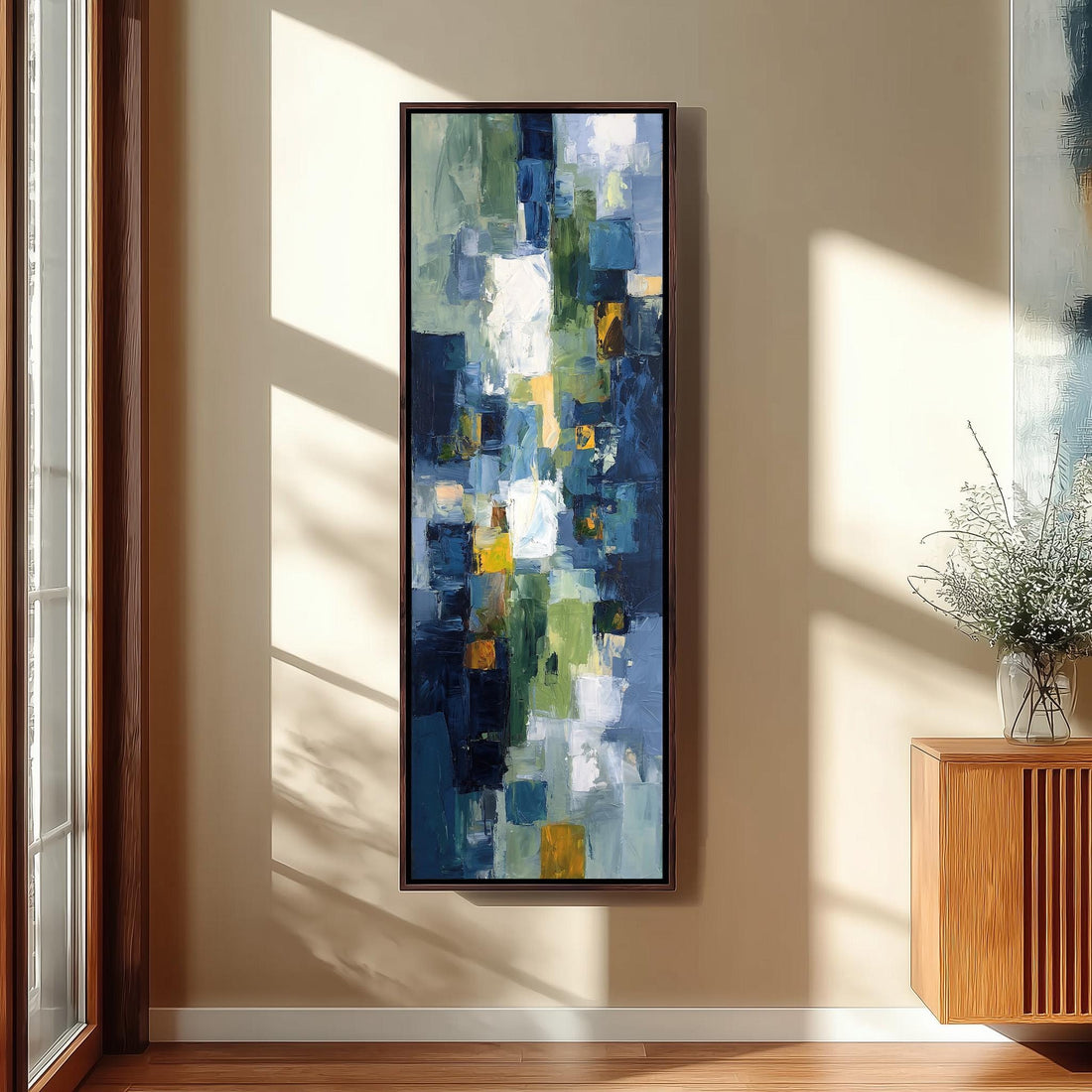 a modern art piece hanging on the wall of a hallway, with a wooden staircase and a bench in the foreground.