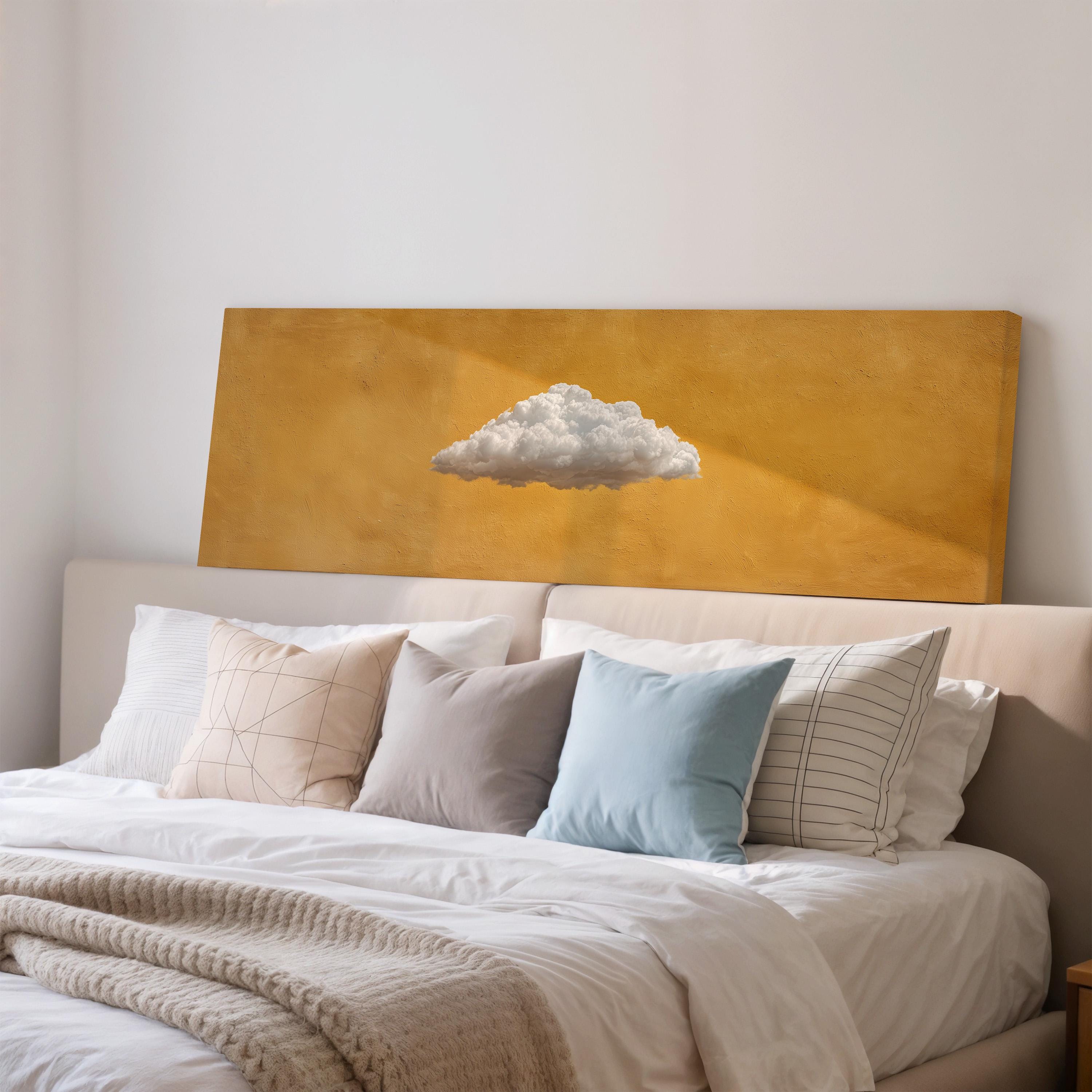 a cozy bedroom with a bed adorned with white sheets and a single blue pillow. Above the bed, there is a large canvas print depicting a cloud on a yellow background.