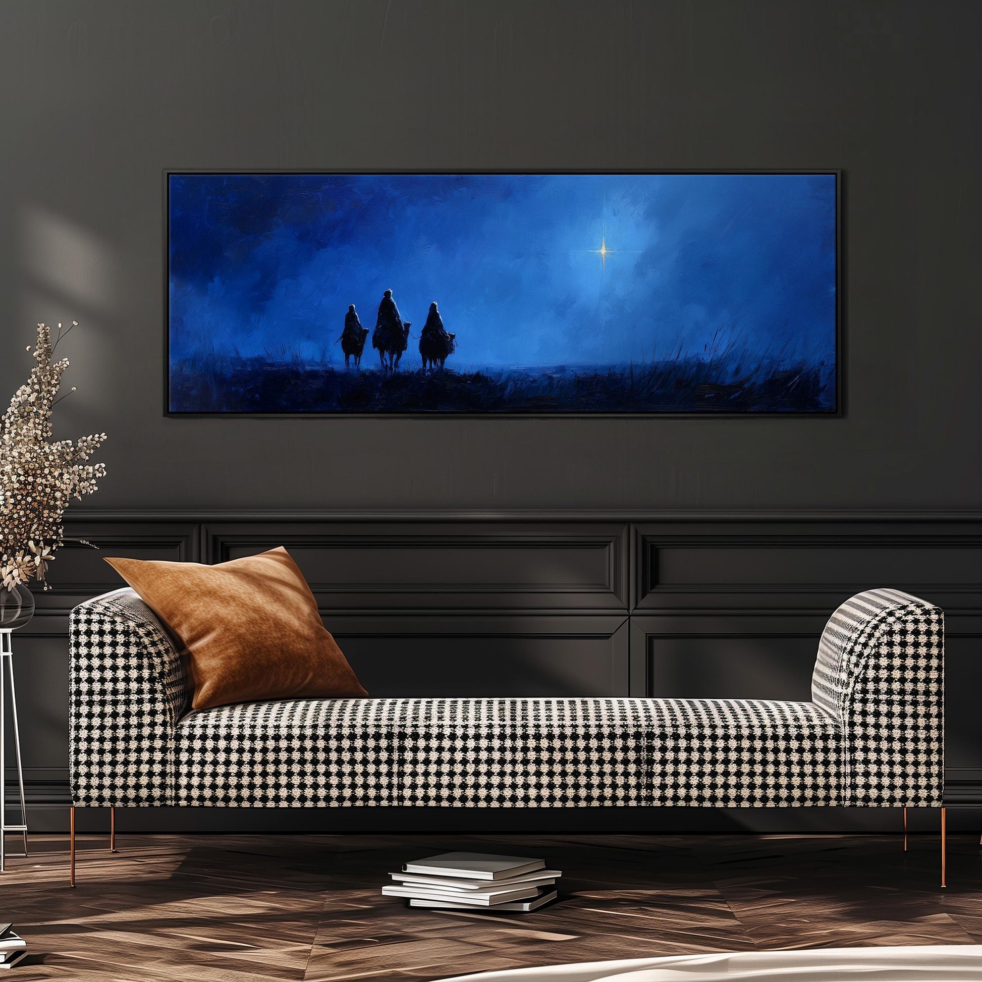a large black and white checkered sofa with a brown throw pillow, positioned in front of a dark wall with a framed painting depicting three figures silhouetted against a night sky.