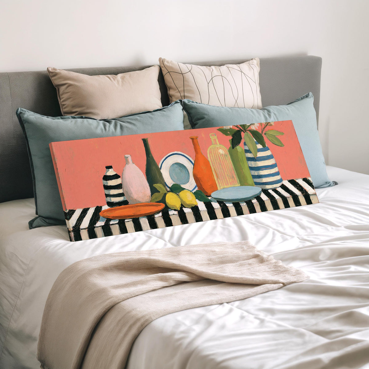 Bottles and lemons still life wide panoramic canvas print laid on a bed to show its size