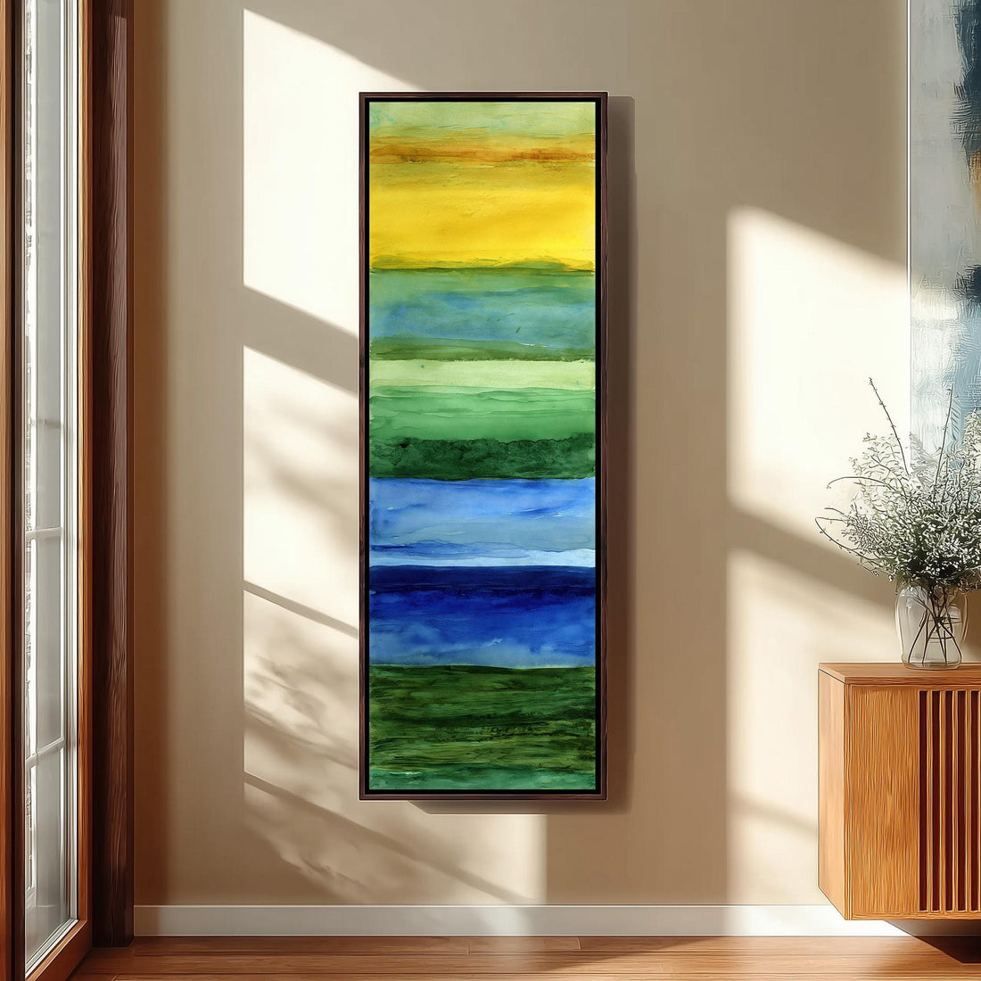 a vibrant, abstract painting hanging on a wall, depicting a colorful landscape with various shades of green, blue, and yellow.