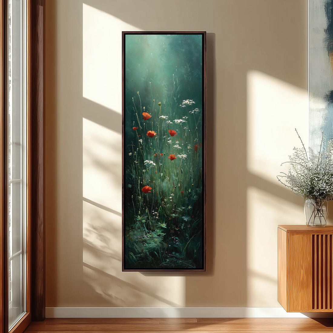 a large painting of red poppies and white flowers hanging on a wall in a room with a wooden cabinet and a window.